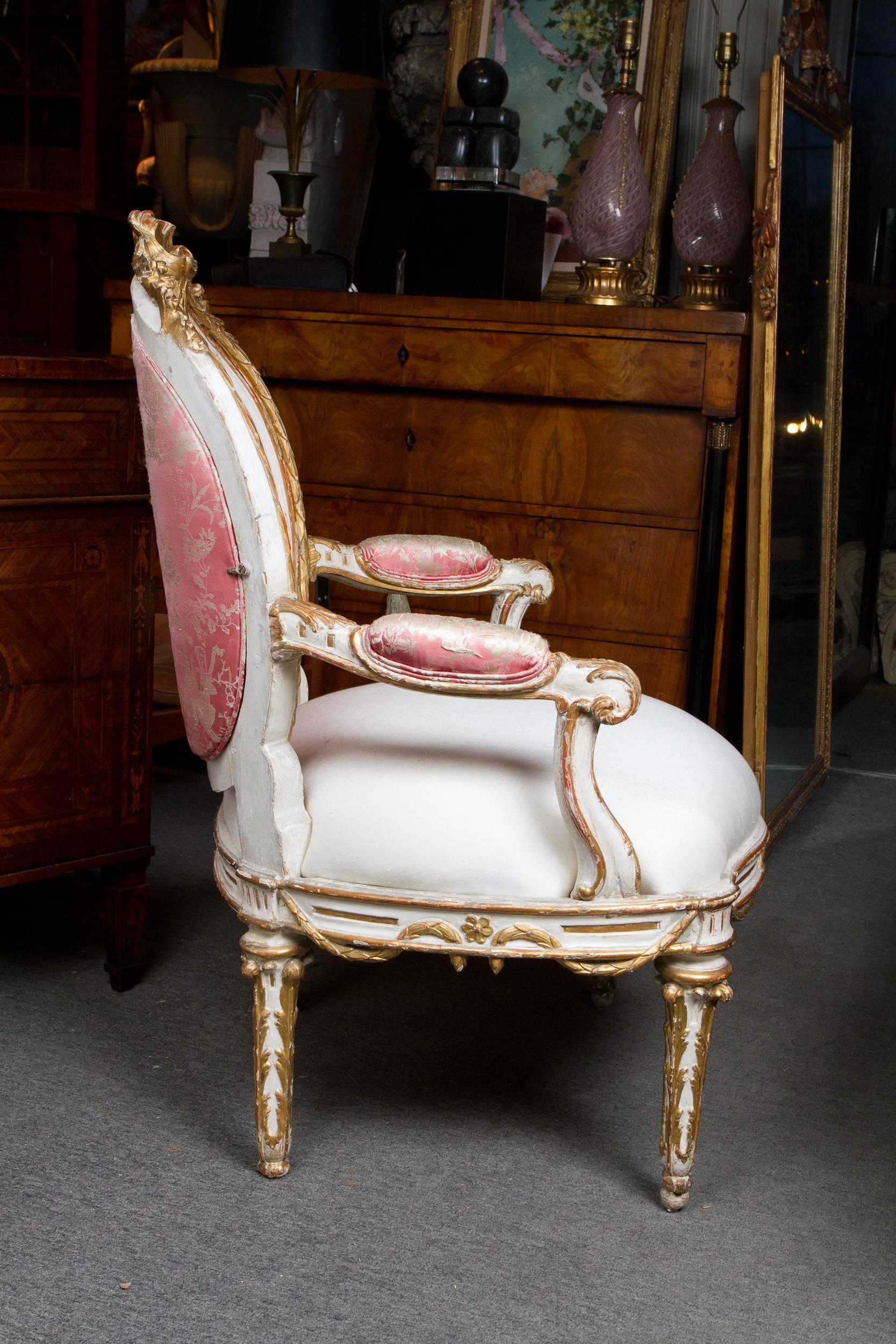 Elegant gilded and white painted upholstered Italian Louis XVI style armchair.
Provenance: Collection of corey hart's family.