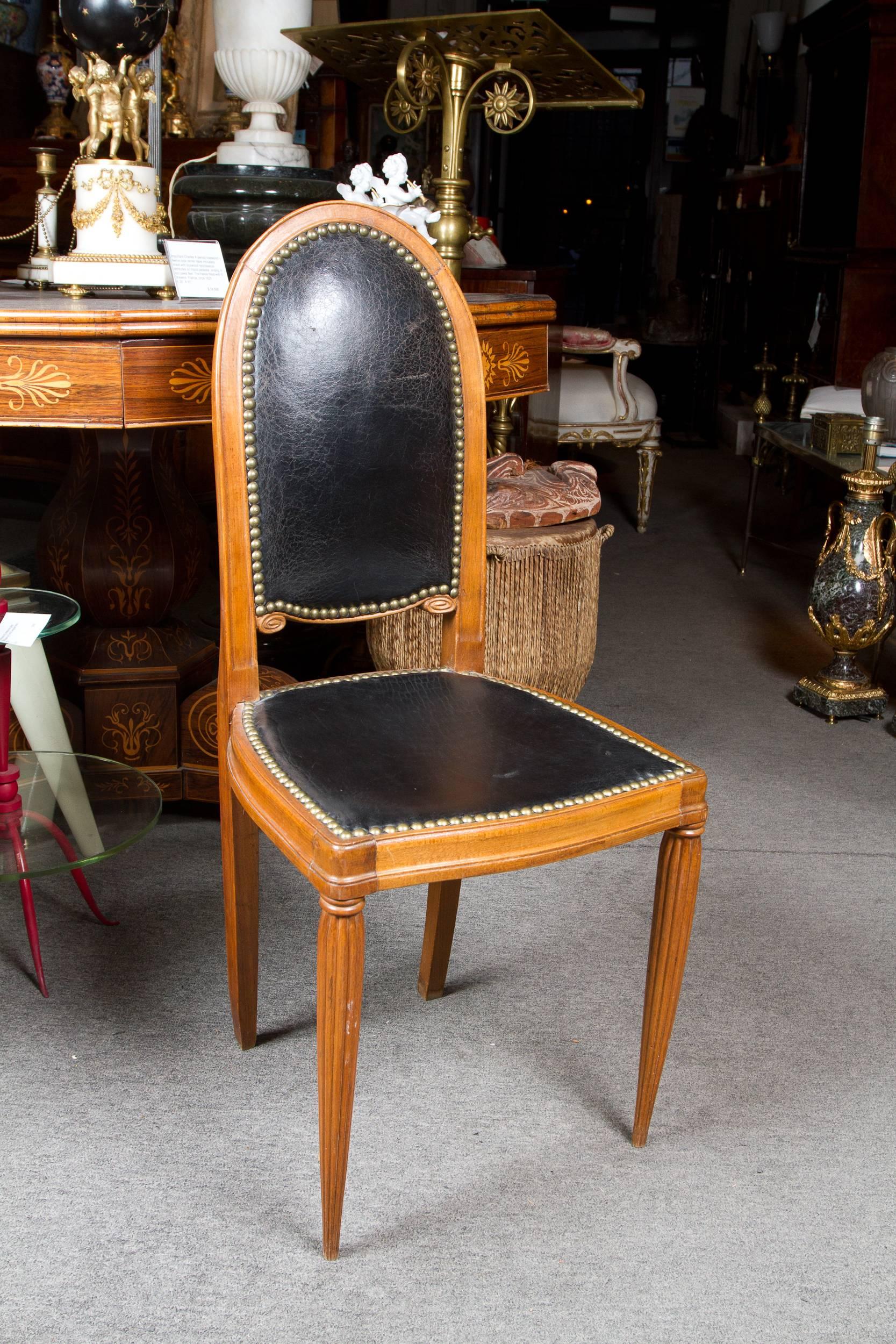 Elegant pair of walnut Art Deco side chairs in the style of Paul Follot upholstered in vintage black leather.