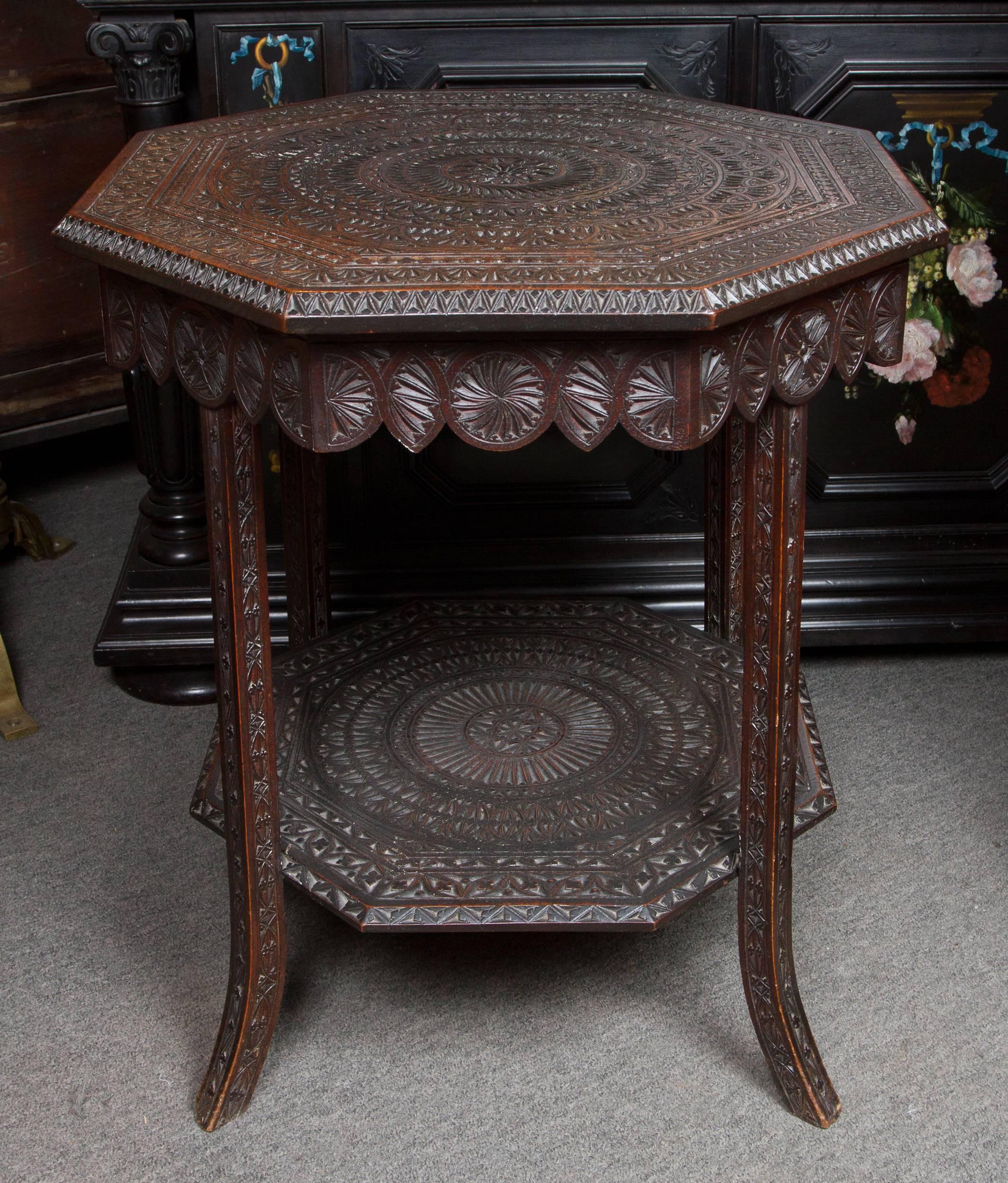 Great Arts & Craft period carved wood octagonal side table with Celtic style design. Bearing label under top: Bowman Brothers, Camden town, London , NW 1.