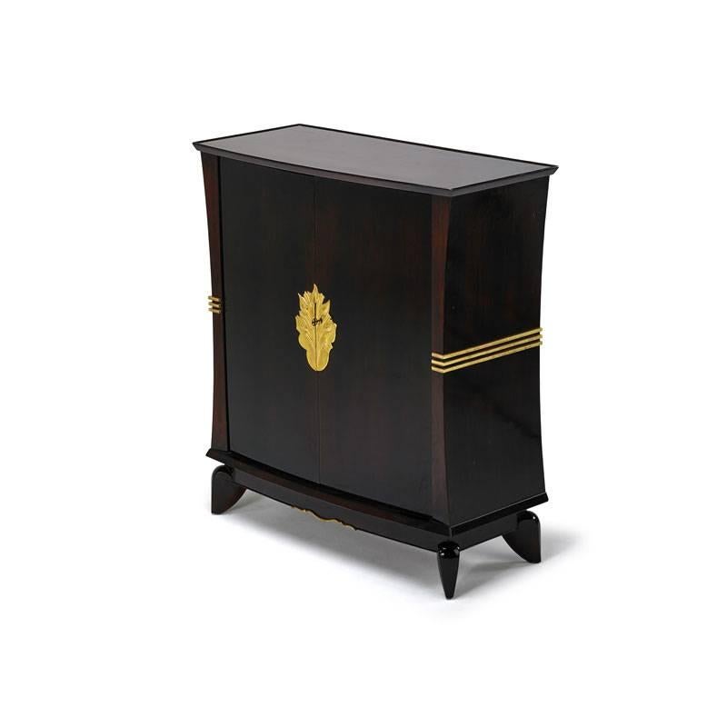 Lacquered and stained Art Deco mahogany bar cabinet with gilt wood decorations and onyx shelves inside by Maurice Jallot.