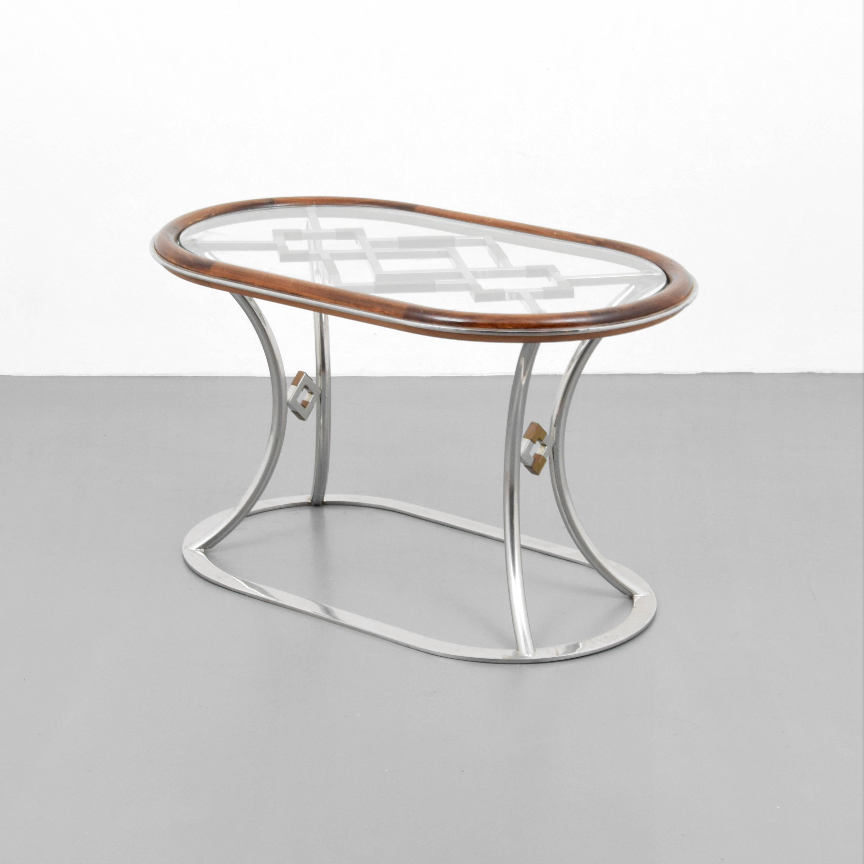 Stylish pair of steel and brass side tables by Alain Delon for Maison Jansen.