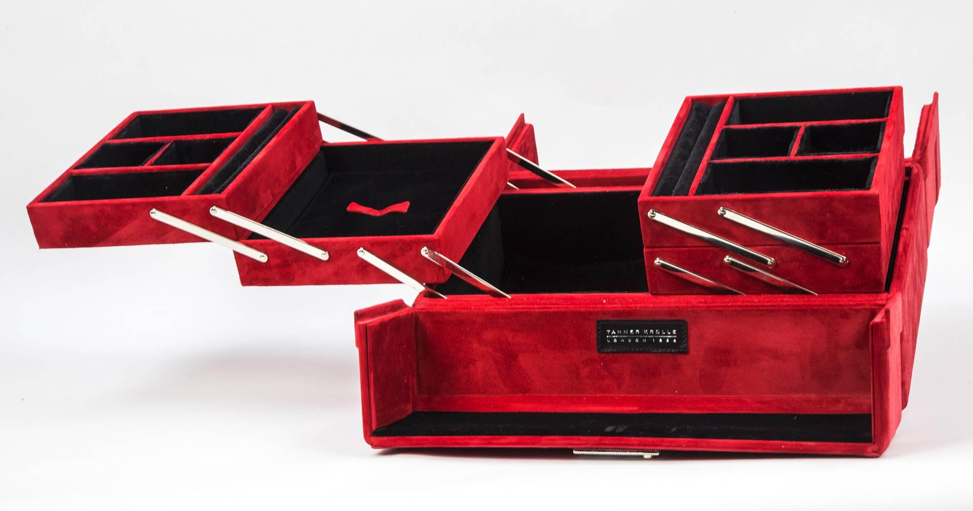 Curating luxury with a magnificent Tanner Krolle large red suede jewelry case, fully lined in black suede leather; comes with Tanner Krolle large white protection bag; The grandest luggage money can buy…It's a British firm called Tanner Krolle.