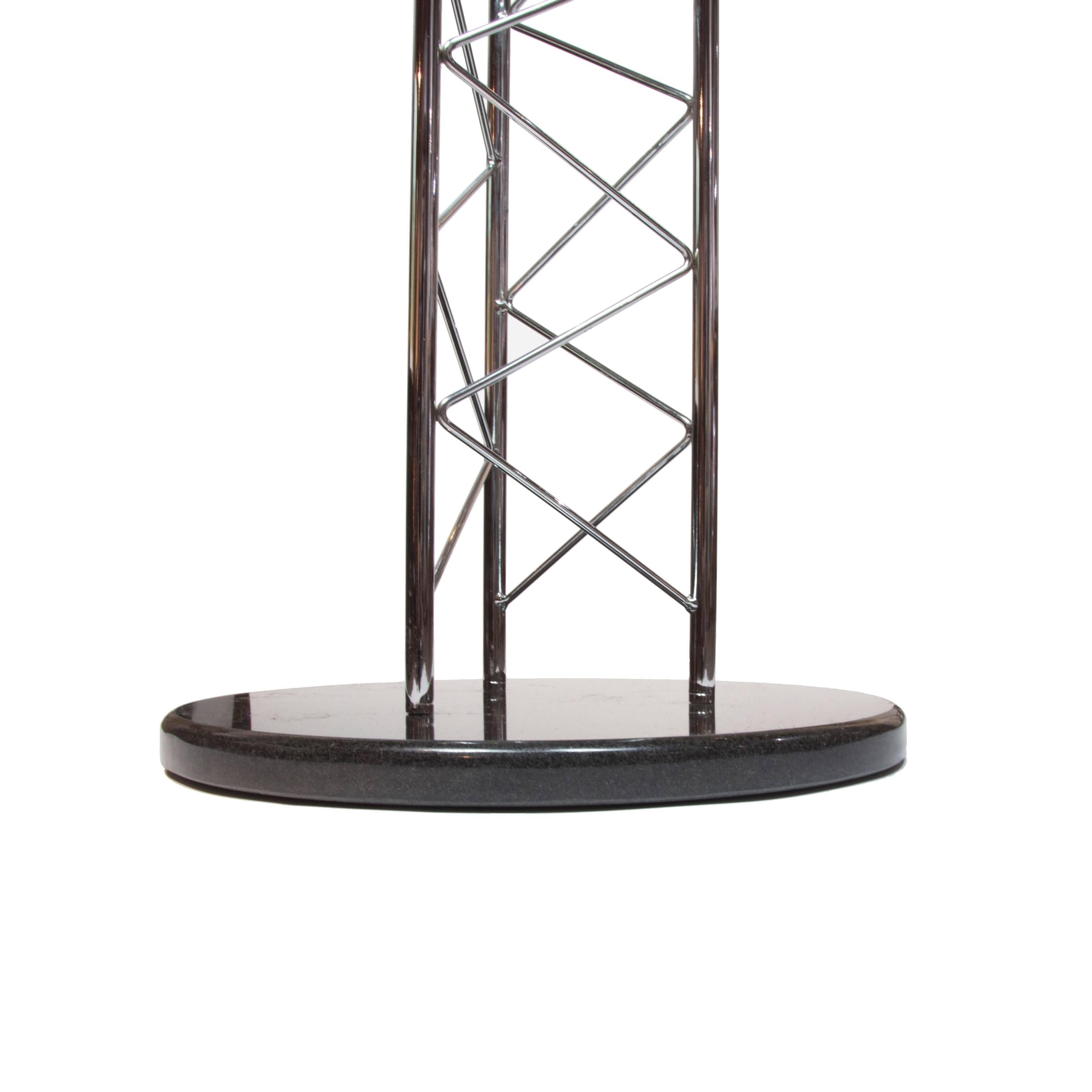 Chic Avant-Garde Mid-Century Modern truss side table features a chrome sculptural base and the round tabletop is thick glass with a polished edge.
   