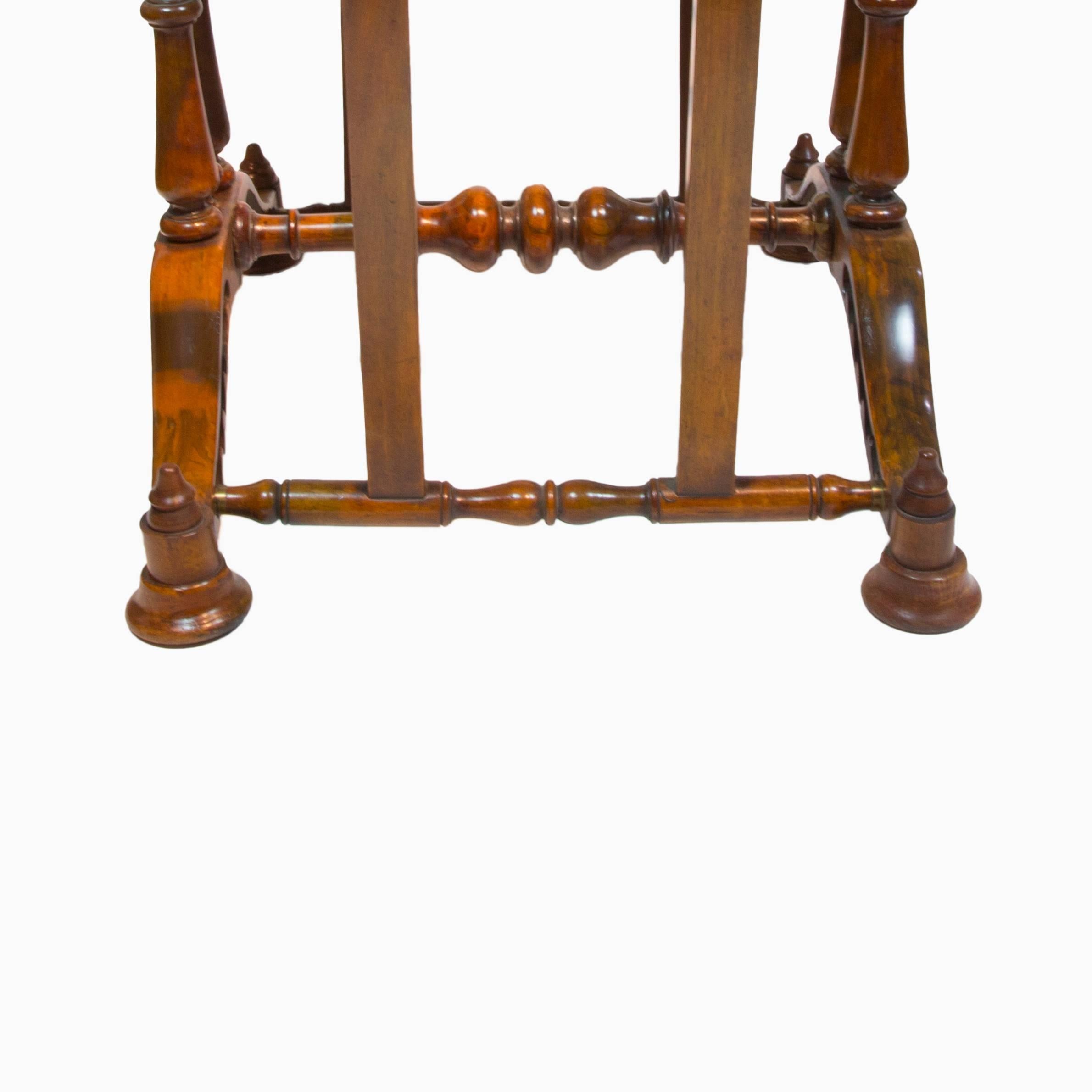 The mahogany birdcage Folio style base, centering beneath six round mahogany spindle columns and four 2’ x 4’ flat mahogany column; approximate measurements: table - 46