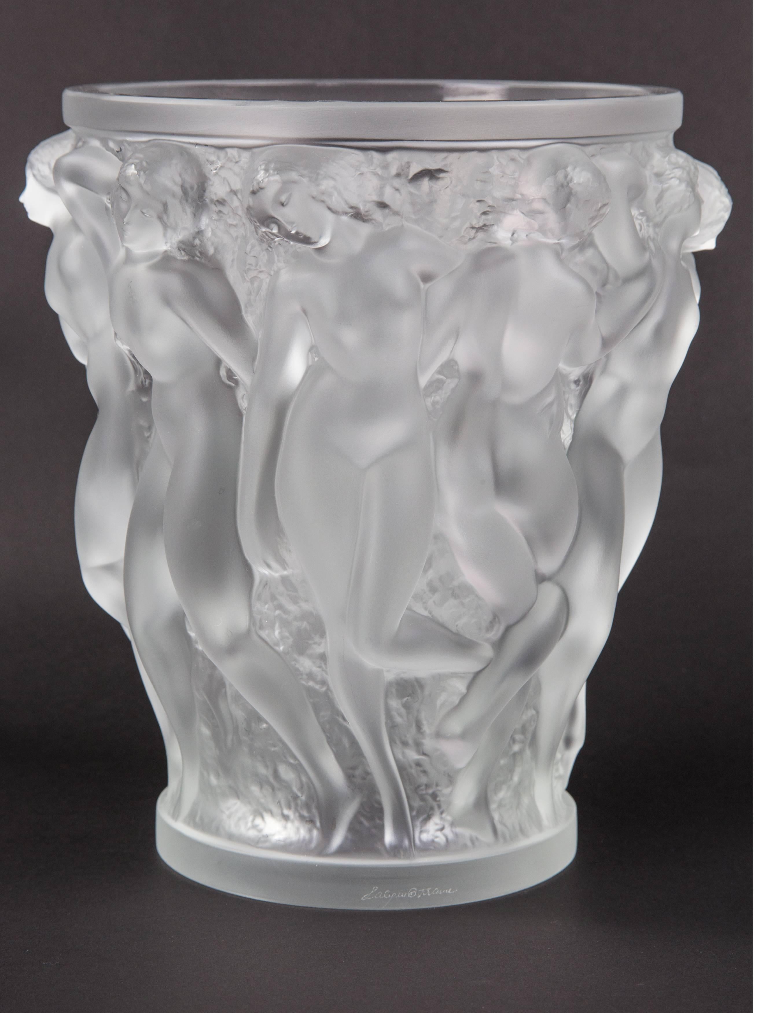 Breathtaking large Lalique bacchantes vase deeply molded with a frieze of nude figures; celebrates the beauty of the female figure; signed in script: Lalique France; This iconic vase is celebrated for its intricate and abundant sculptures of the