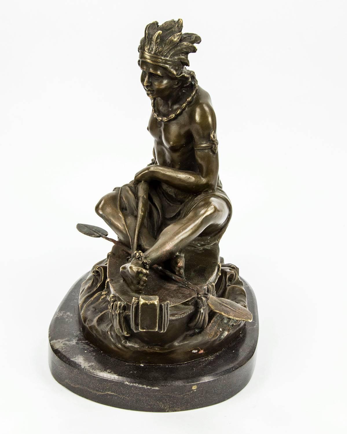 Striking bronze sculpture of a native American Indian chief, dressed in fancy native American attire, resting his feet at the front of the canoe, signed: Duchoiselle: atop a marble base. Bronze measures approximately: 14.5
