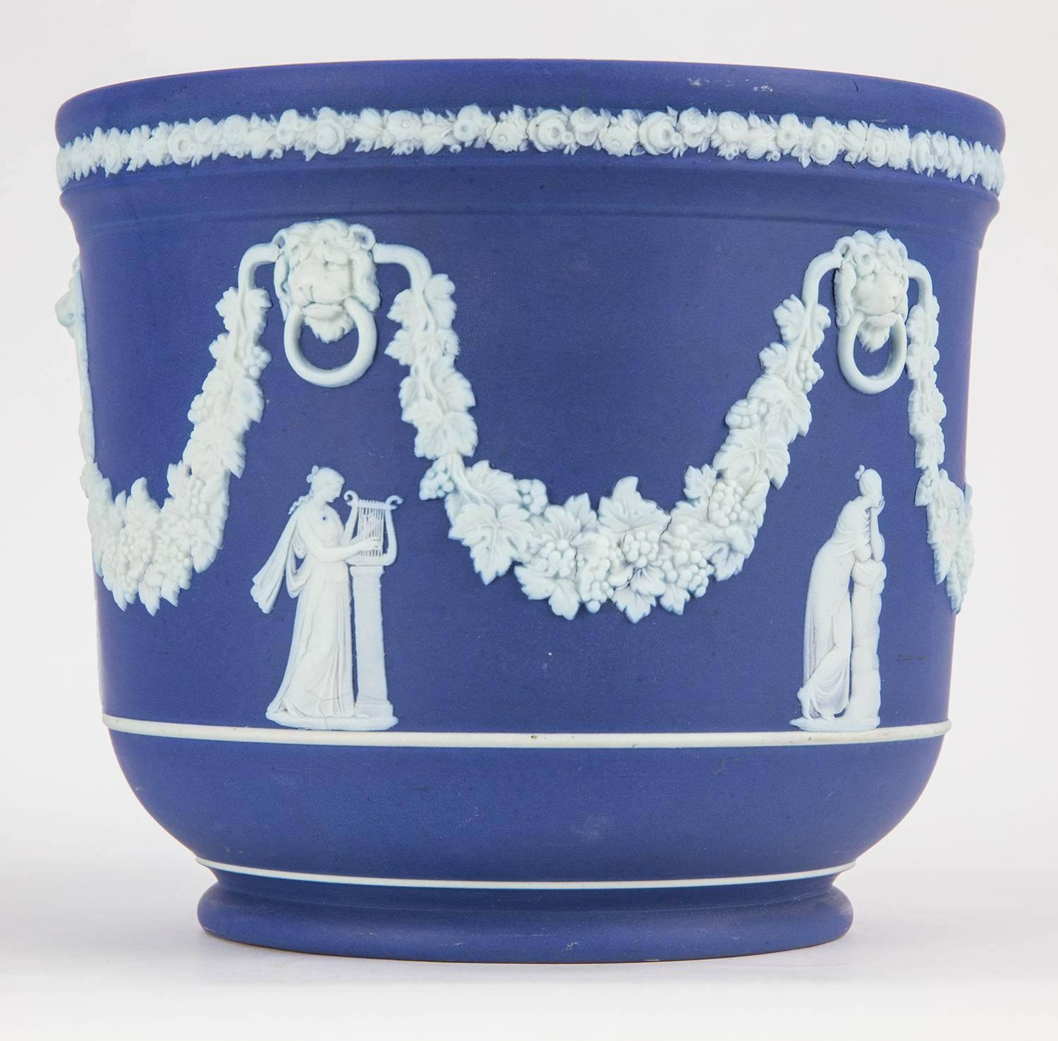 Estate Wedgwood Blue Jasper Heirloom Quality Cache Pot, decorated with applied figures to five sides; above each figure is an applied white lion with a vine leaf swag from behind his head with large leaves and bunches of grapes. Below the raised