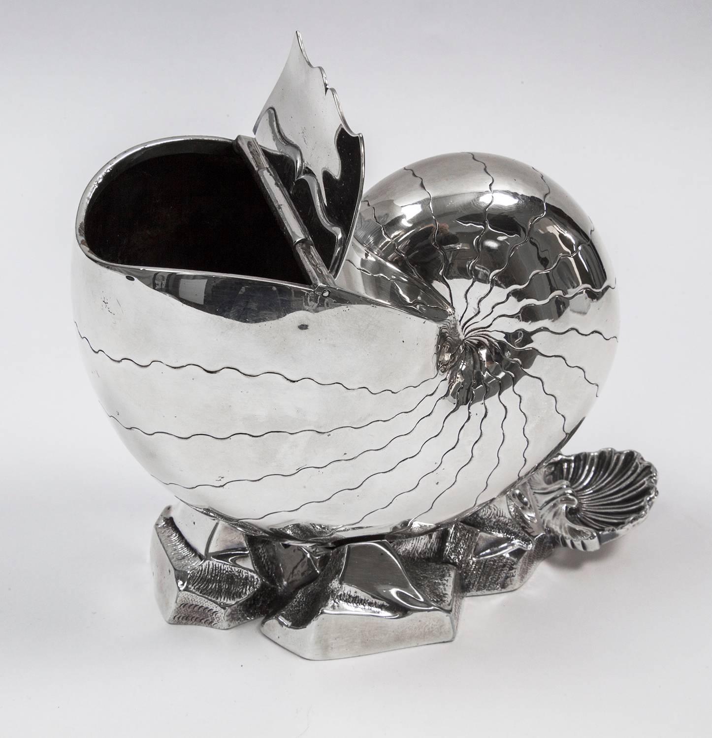 Antique Victorian silver plated conch shell design ice bucket and/or spoon warmer, having a hand-chased body; hinged lid opening, sitting on a rocky base with shell thumb-piece. This fine handmade silver plated spoon warmer measures approximate: 5”