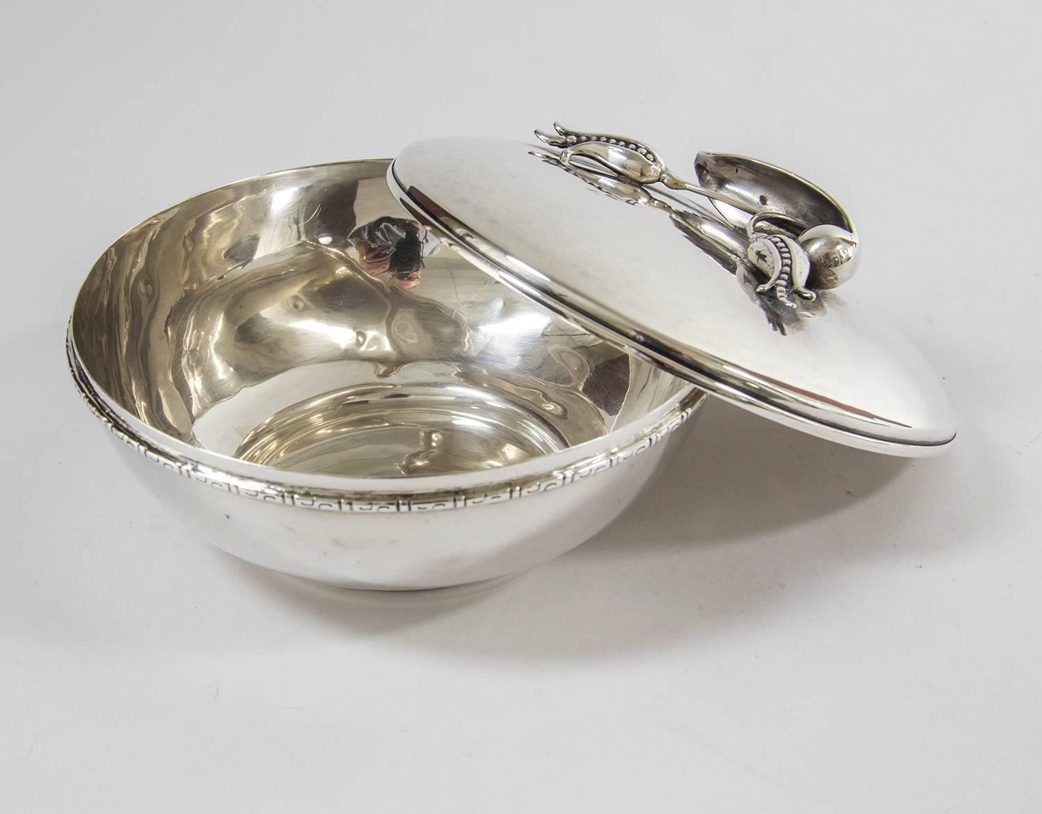 Mid-Century Modern sterling silver covered dish by renowned Canadian Silversmith Carl Poul Petersen, lid adorned with blossom or pea pod like flowers. Hand-hammered; No monograms or engraving; Signed 