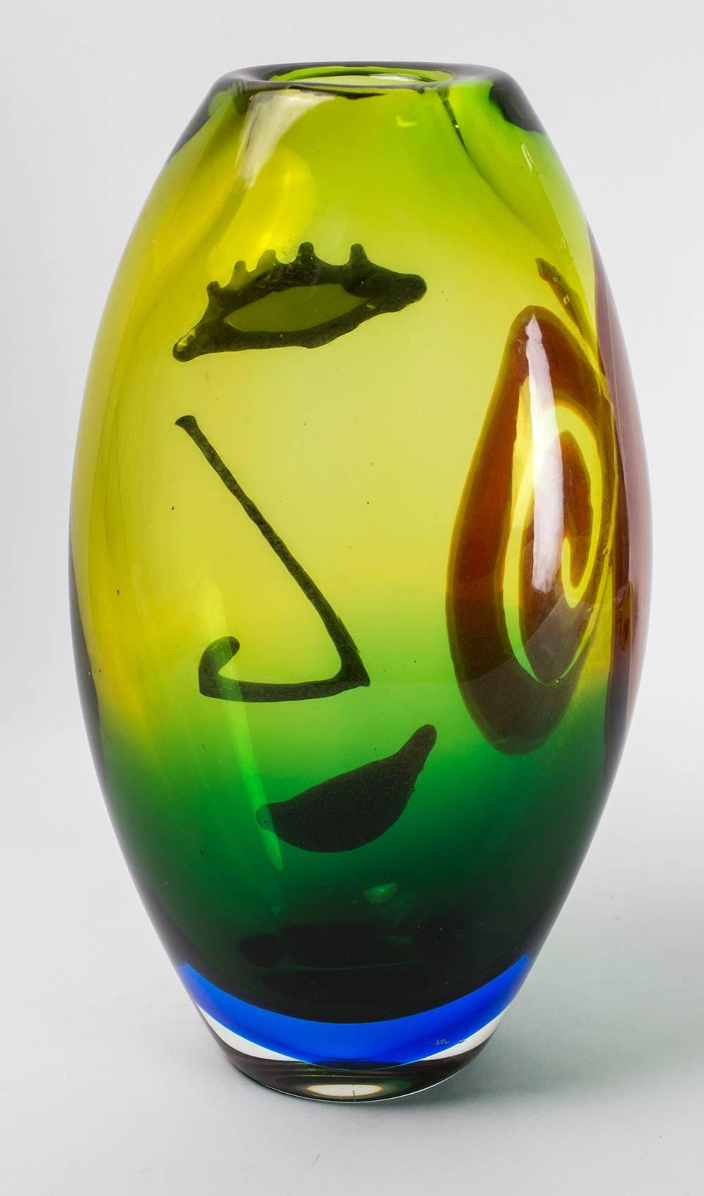 For the lovers of Murano, an alluring abstract Picasso style face design Art Glass Vase. Colorless glass with multi colors and outer murrain facial features; Size: 12 inches high x 7 inches wide x 4 inches. Approx. weight: 4560 grams; A World Class