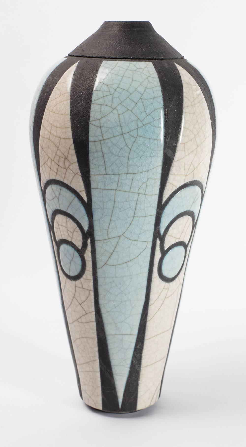 Dynamic American Raku pottery enameled glaze pottery vase in geometric high relief, two-tone blue, grey, white and black Signed on base. Measures: 12” high x 5” diameter.
 
