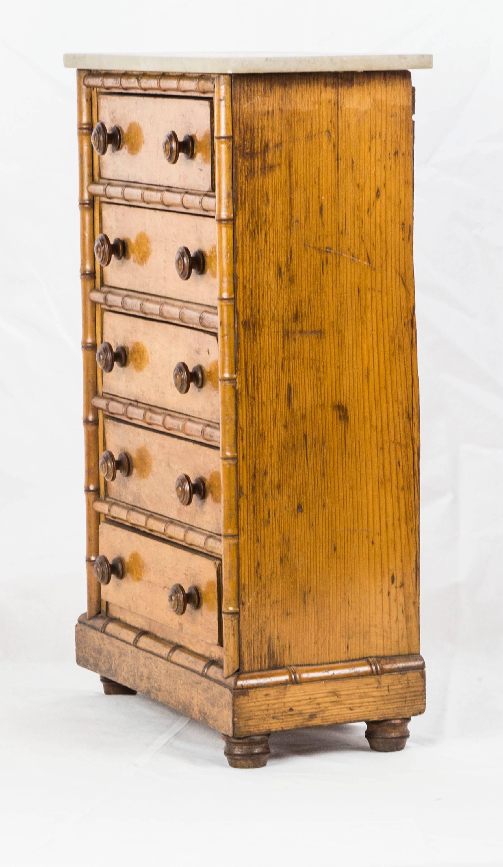 Well proportioned antique five-drawer bird's eye maple and marble top highboy, banded on the sides and between the drawers with faux bamboo maple. The sides and back are made of pine. Beautifully turned knobs and feet complete the chest.