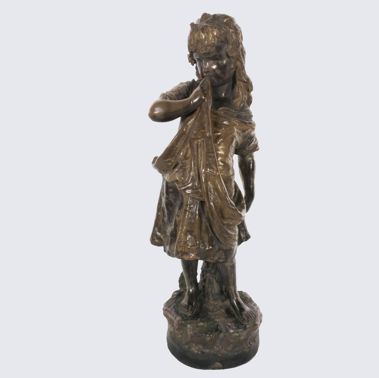 Winning art pottery figure of a young girl, by the Amphora Pottery works of Turn-Teplitz, Bohemia. Posed leaning against a tree trunk on a naturalistic base, she stands shyly sucking on her apron. Her innocent beauty shines through the gentle