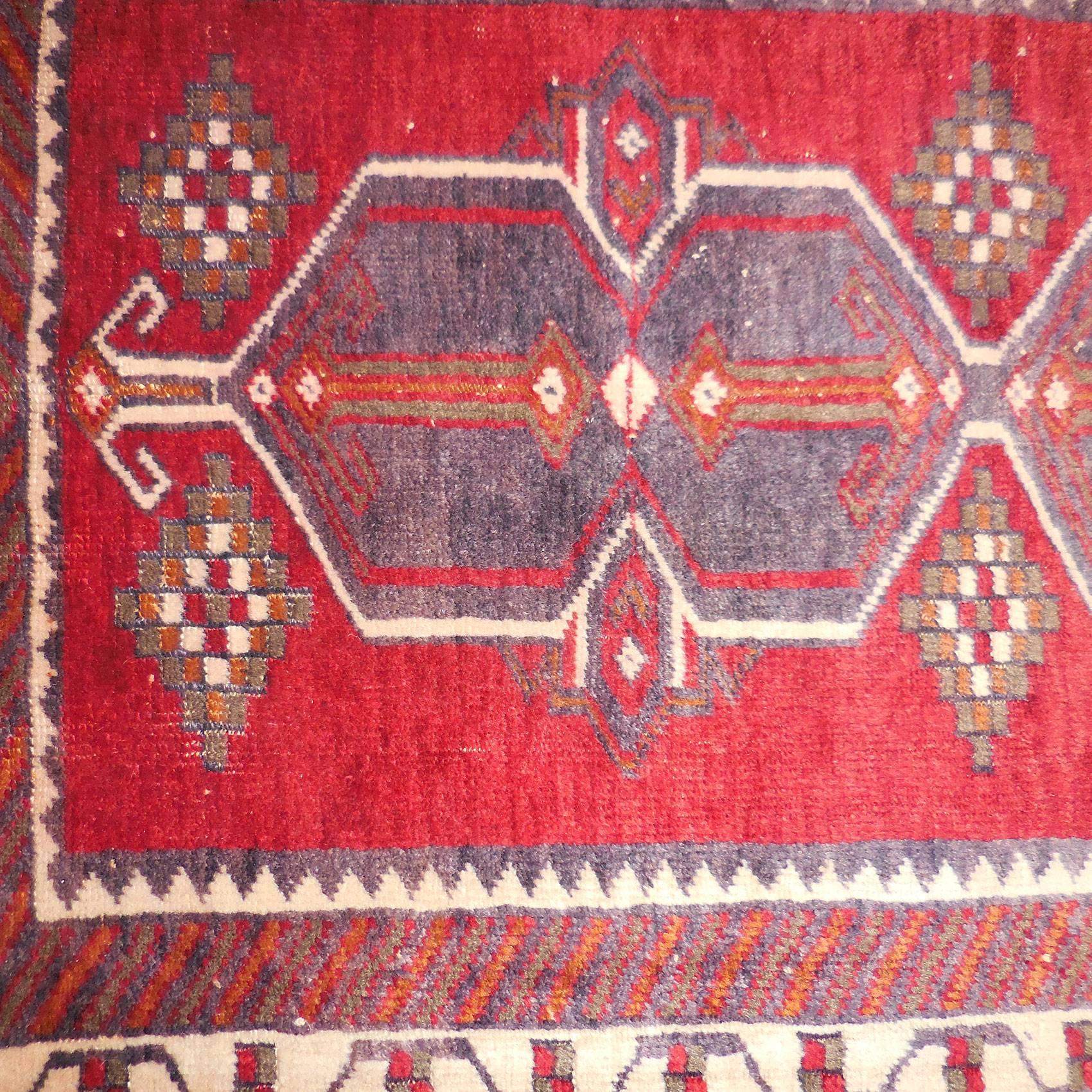 Vintage hand-knotted Turkish Malatya rug from Eastern Anatolia, displaying typical rich coloration and bold forms; a beautifully designed small rug.