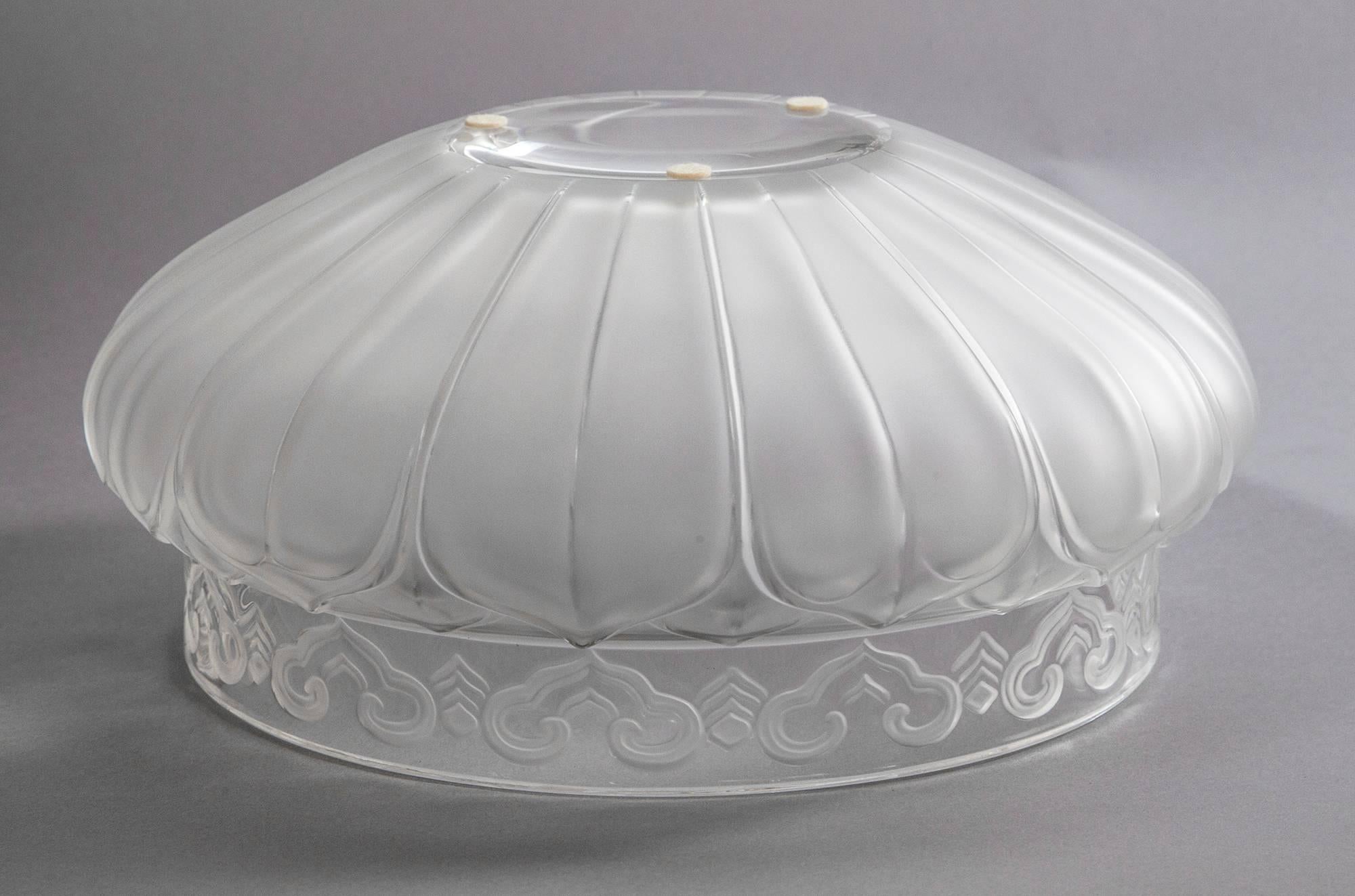 Beautiful Lalique centerpiece bowl in frosted crystal with clear rim and base, embellished with Arabesques and Volutes. Script signature: Lalique France, on base, and Lalique Paris sticker on rim. Sold with original presentation box.
