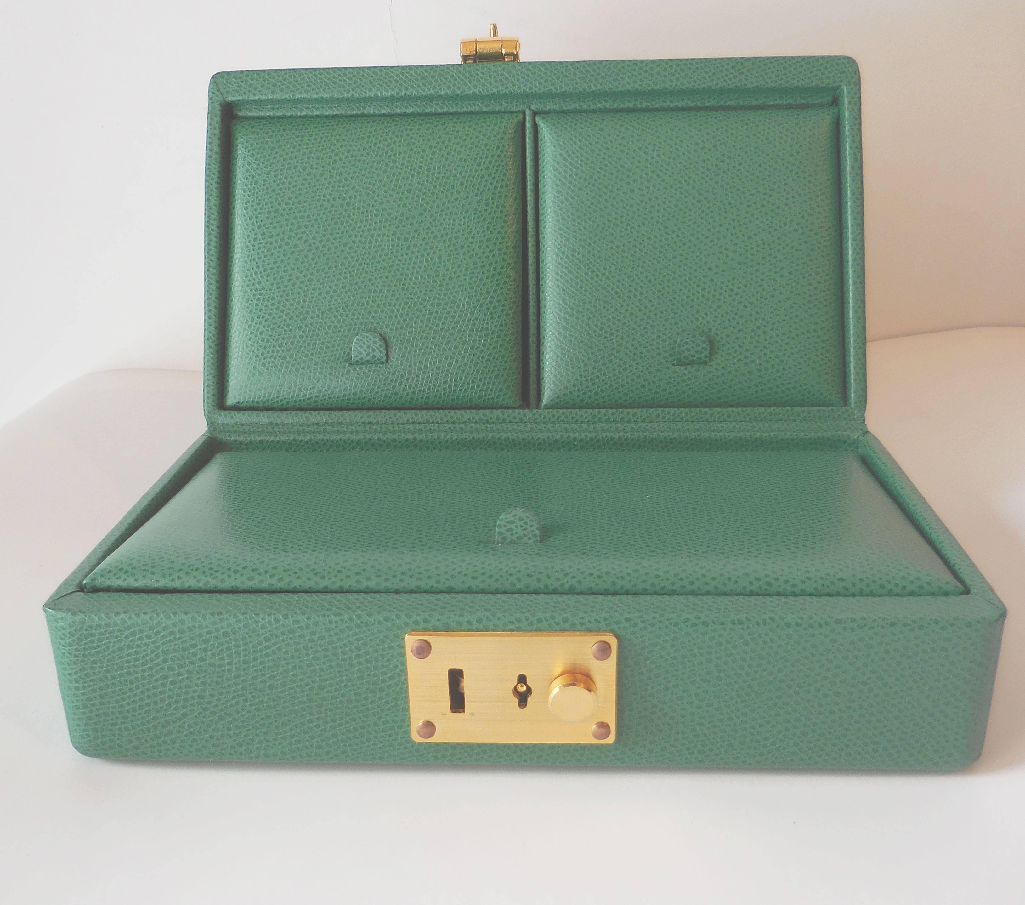 Curating luxury withTanner Krolle green leather jewelry box, a perfect size for travel! The three separate compartments are fitted with dark green velvet linings and protectors. Fitted with lock and key. An exceptional gift for that very special