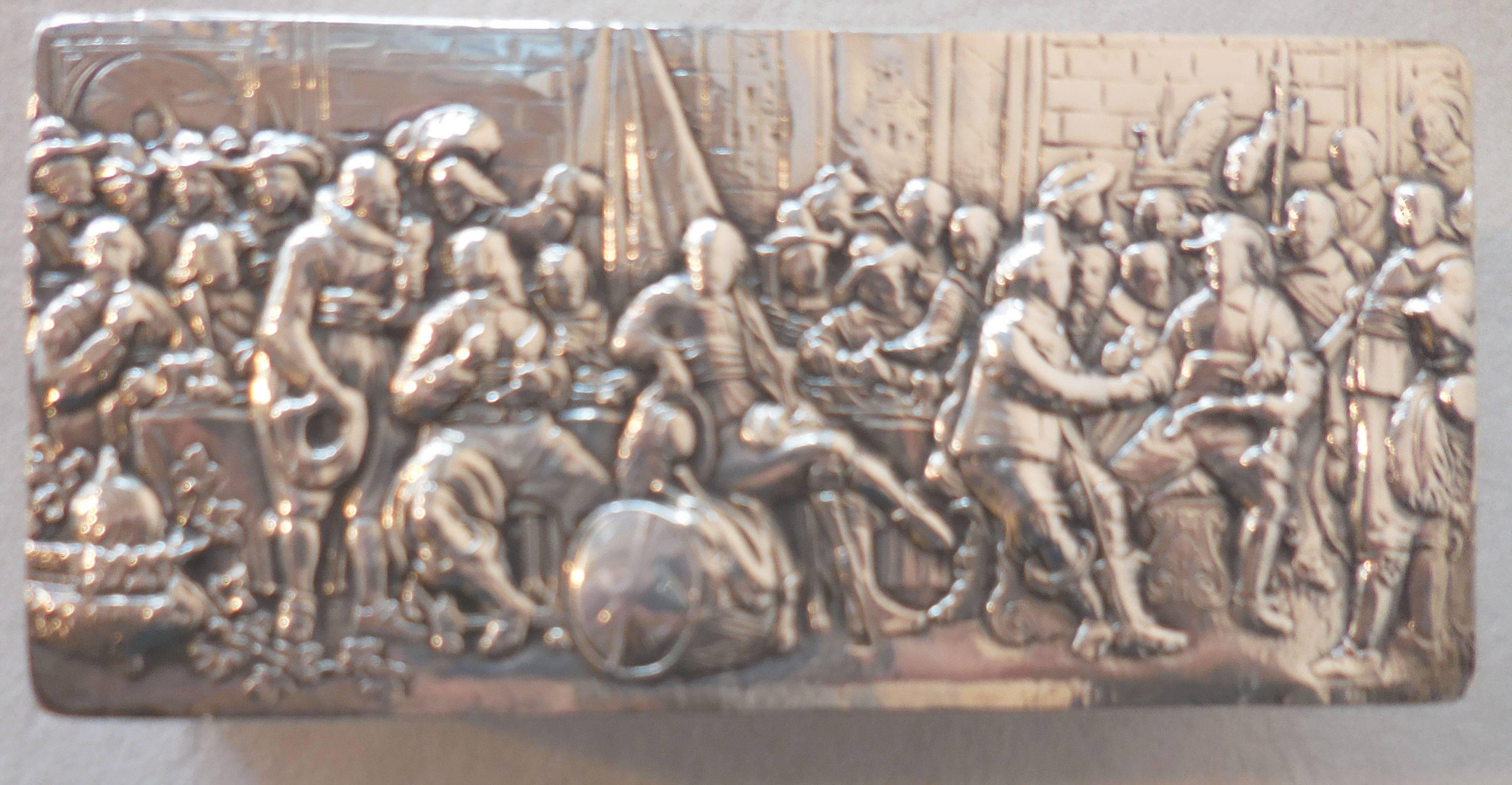 Antique Dutch repoussé silver trinket box raised on bun feet, the hinged cover depicting a genre scene, celebrating the Peace of Munster, after the original by Bartholomeus van der Helst. The four sides are embossed with scrolled cartouches