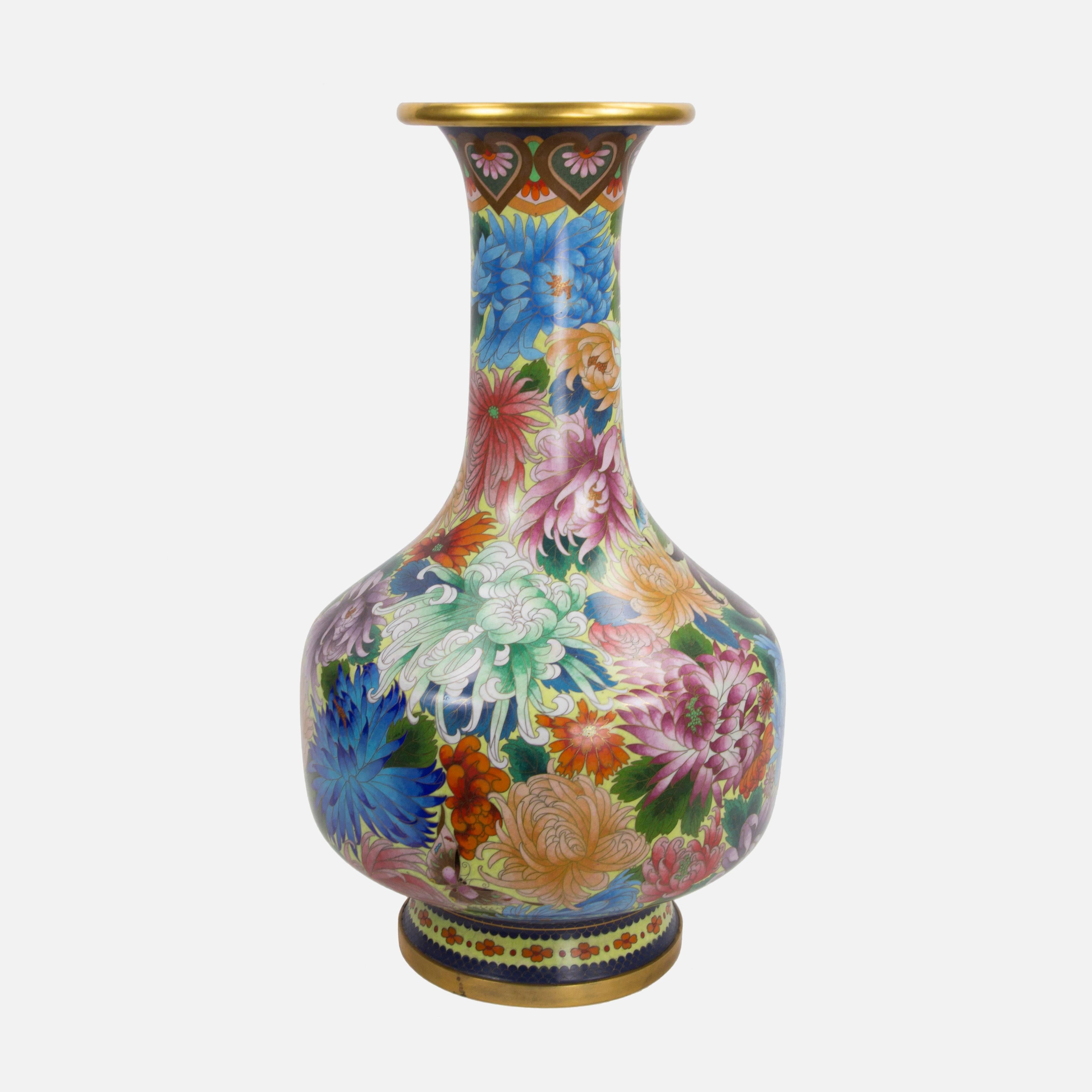 Stunning colorful Chinese Cloisonné enamel case fully decorated with beautiful luscious floral designs featuring chrysanthemums; heavily gilded brass top; banded brass base. Approx. measurements: 29” high, including 4” high wood base; 15.5” center