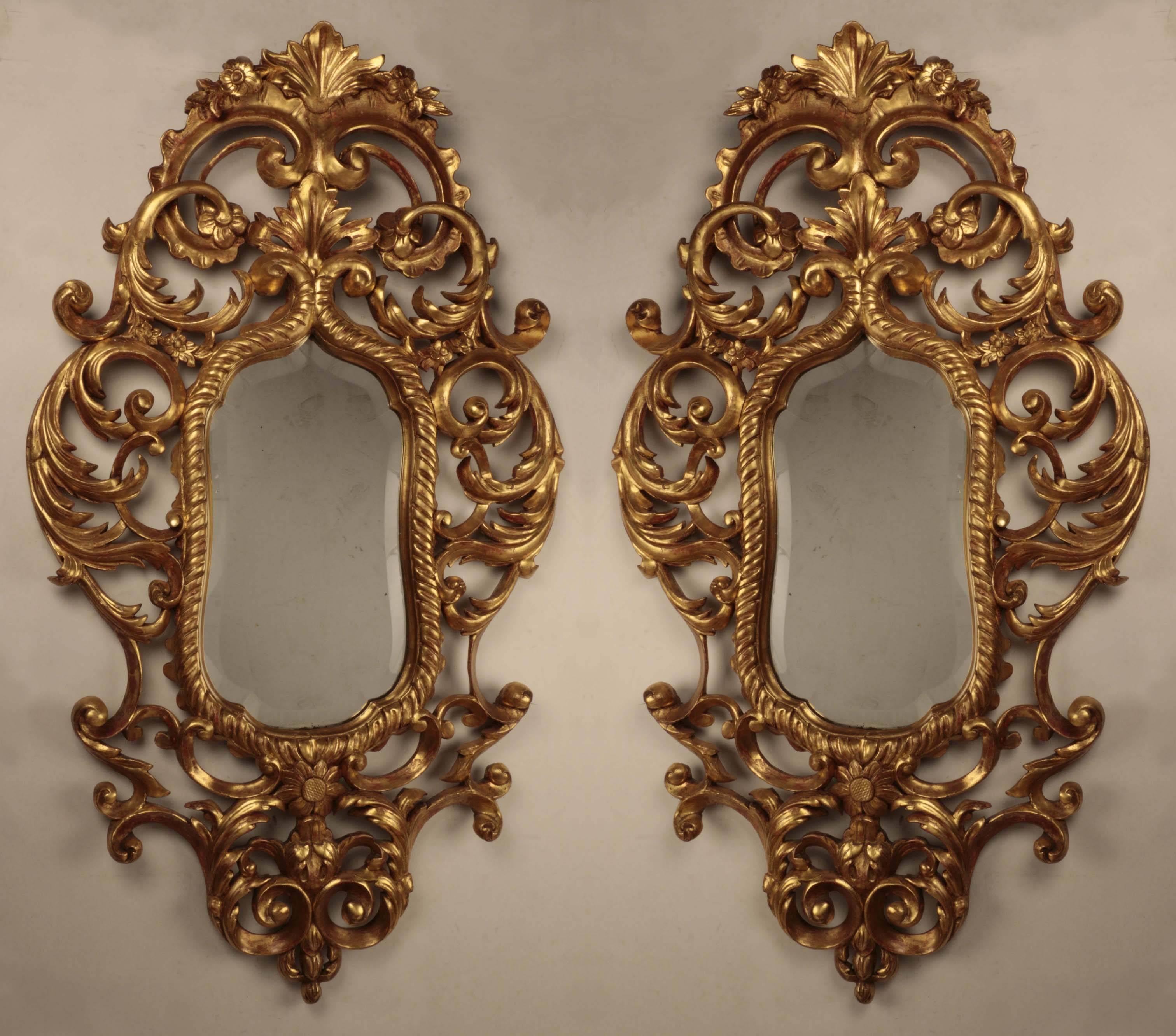  We have taken some photos of the backs of both mirrors to try to convey their age . Clearly, they are antique, but they seem to be quite unusual. We can find no other similar pair from the many available. The carving is crisp, the gilding is well