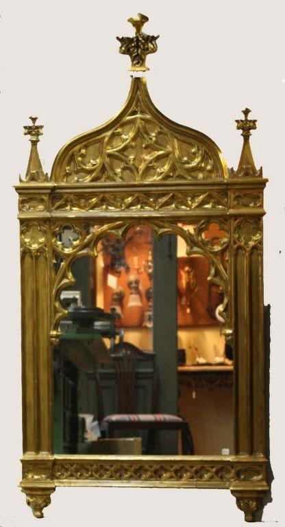 This large boldly carved and gilt mirror , with its trefoil finial and arcaded outline has considerable decorative impact. Its condition is outstanding