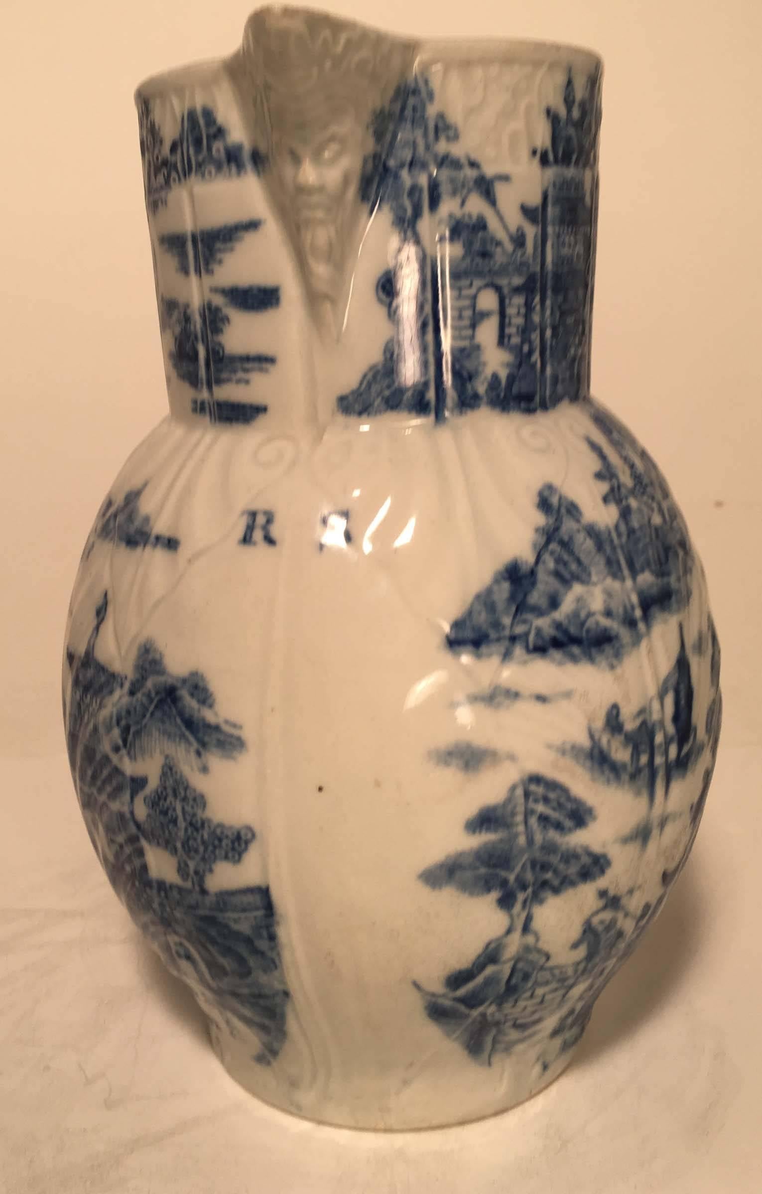 Worcester porcelain cabbage leaf and mask spout jug, with double scroll handle, having original owner's initials,(R S) transfer printed with blue and white chinoiserie decor; unmarked.