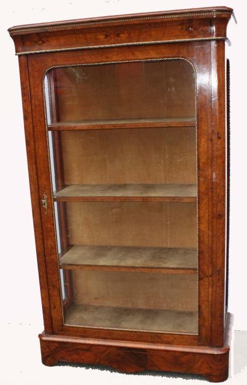 Victorian figural walnut and marquetry triple glazed display cabinet, the door side windows and frieze banded with rope of gilt bronze, with original lock and key; the interior back and the three adjustable shelves lined in velvet. This cabinet is