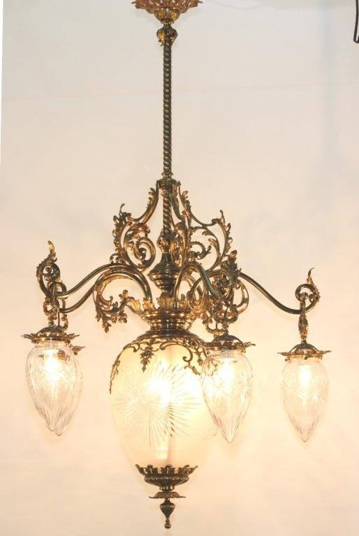 Victorian cut-glass and gilt bronze six-light chandelier, the rope twisted stem centers a frosted and cut-glass pear-shaped  globe with foliate finial and with five ornately scrolling foliate arms suspending identical but smaller shades 

This is a