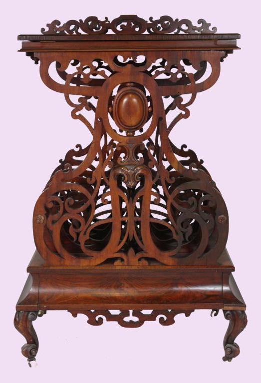 Victorian canterbury with adjustable book stand and pivoting candle stands over three fretwork folio dividers above one concave frieze drawer, raised on cabriole legs .
This is a very high style Victorian piece. 