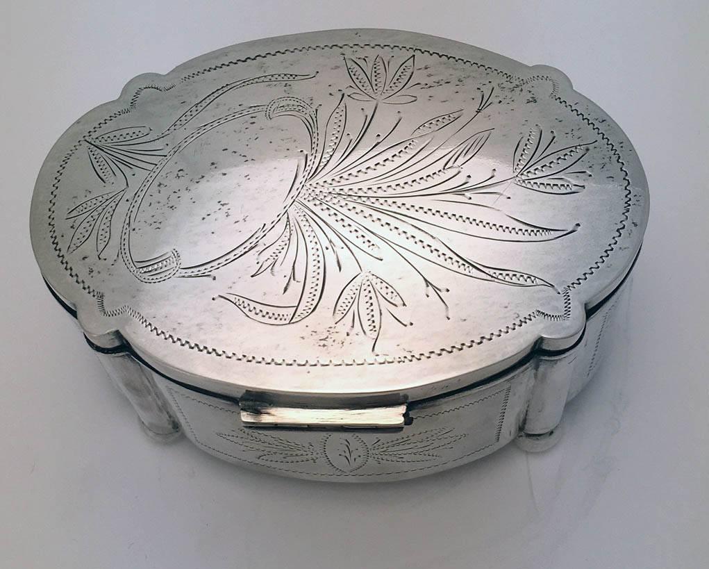 Judacia: Polish silver etrog box, of shaped oval outline and raised on ball feet, the body engraved with leaves, the hinged cover engraved with leaves and a stylized, etrog .800 standard, circa 1925.
Unlike many silver boxes used for the