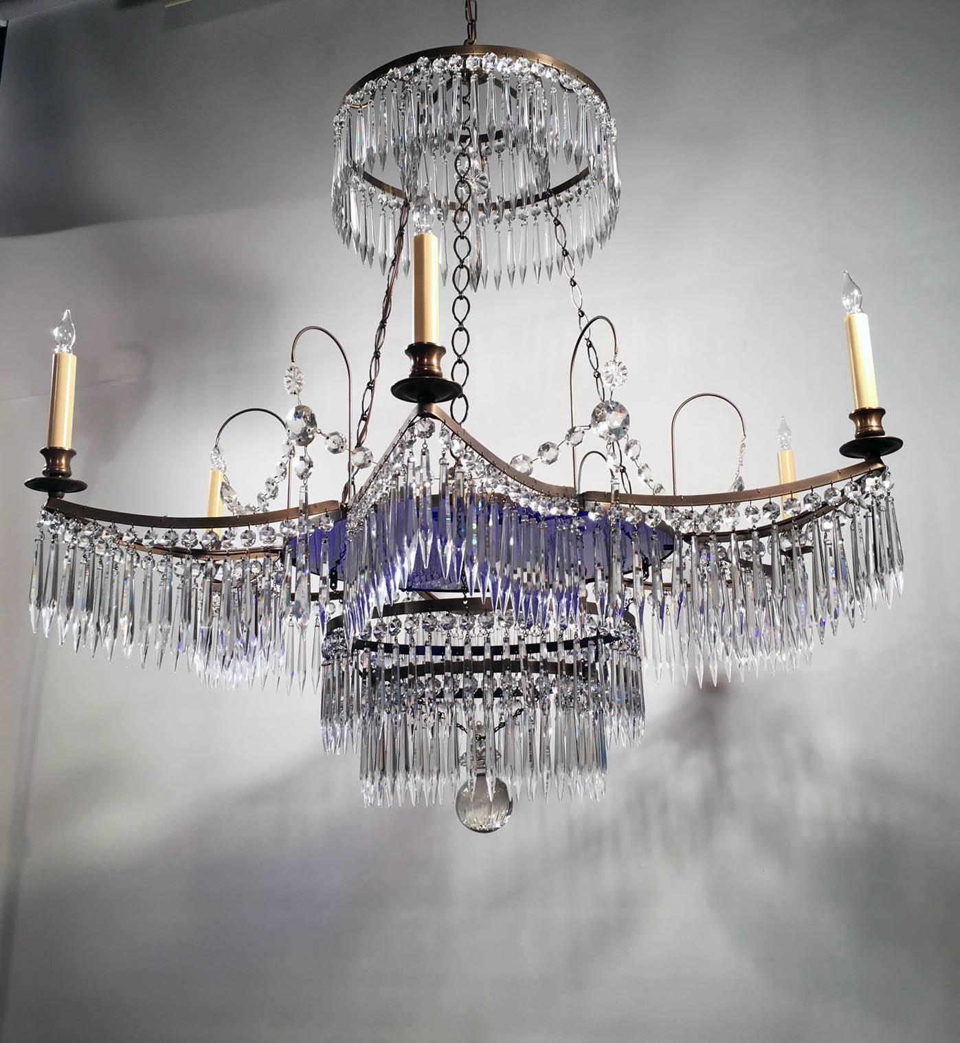This large six-light chandelier is bordered by six curved sides, which makes it star-shaped, the central cobalt blue glass circular plate surmounts a graduated two-tier band and is in turn surmounted by a down swept canopy, . The entire chandelier