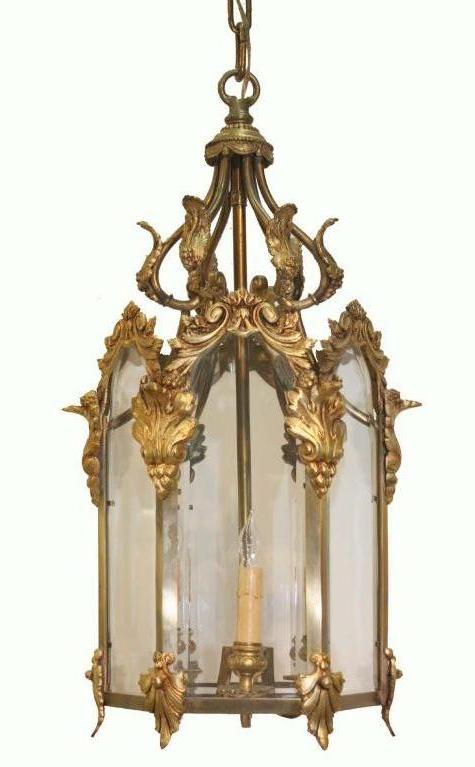 Louis XV style three-light hexagonal lantern fitted with beveled glass panels  , the frame applied with foliate forms.