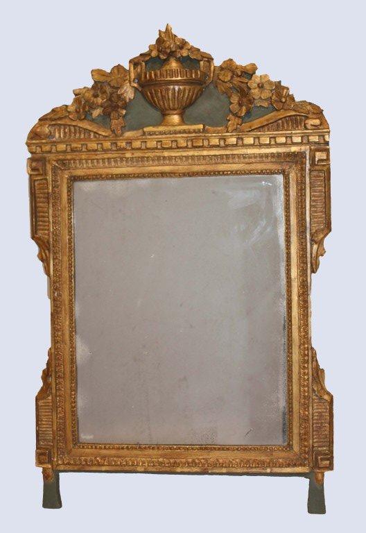 Louis XVI period carved painted and parcel giltwood wall mirror with pediment centered by urn and cascading flowers.