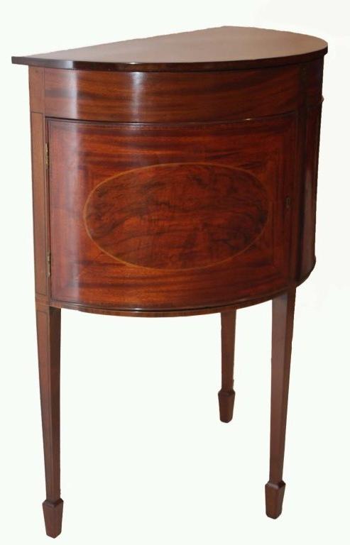 Sheraton style mahogany two door commode, the lid with fan shaped inlay lifts to reveal  a fitted interior,  raised on tapered square legs on spade feet.