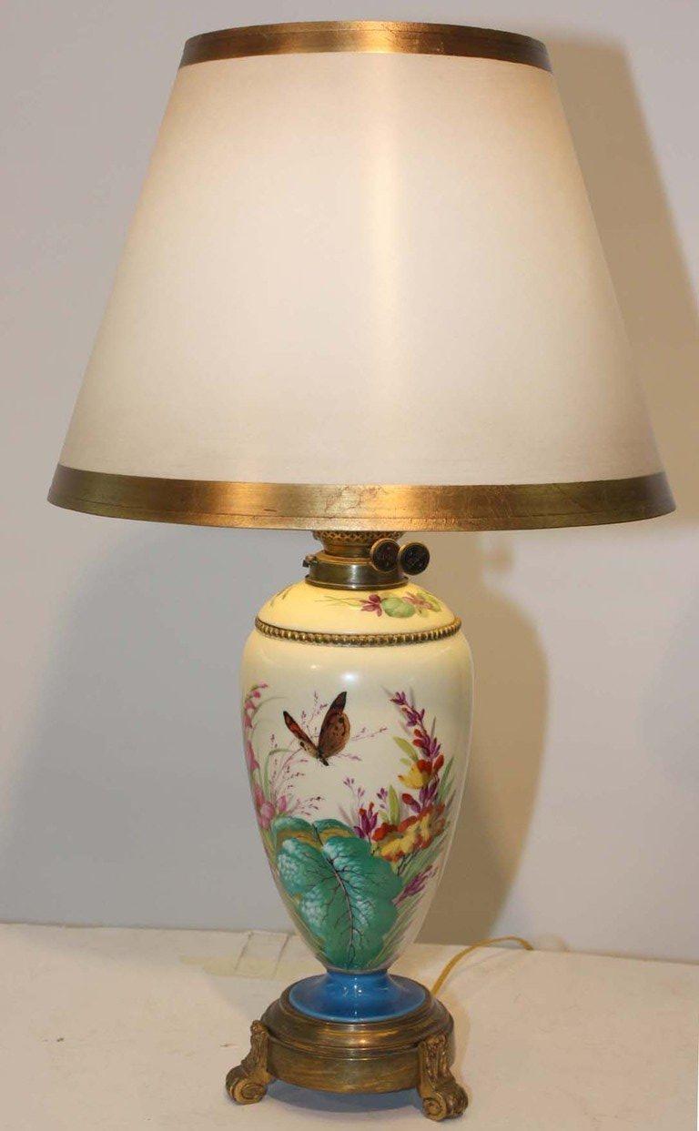 Victorian Duplex oil lamp with porcelain hand-painted reservoir on brass base; later adapted to electricity.