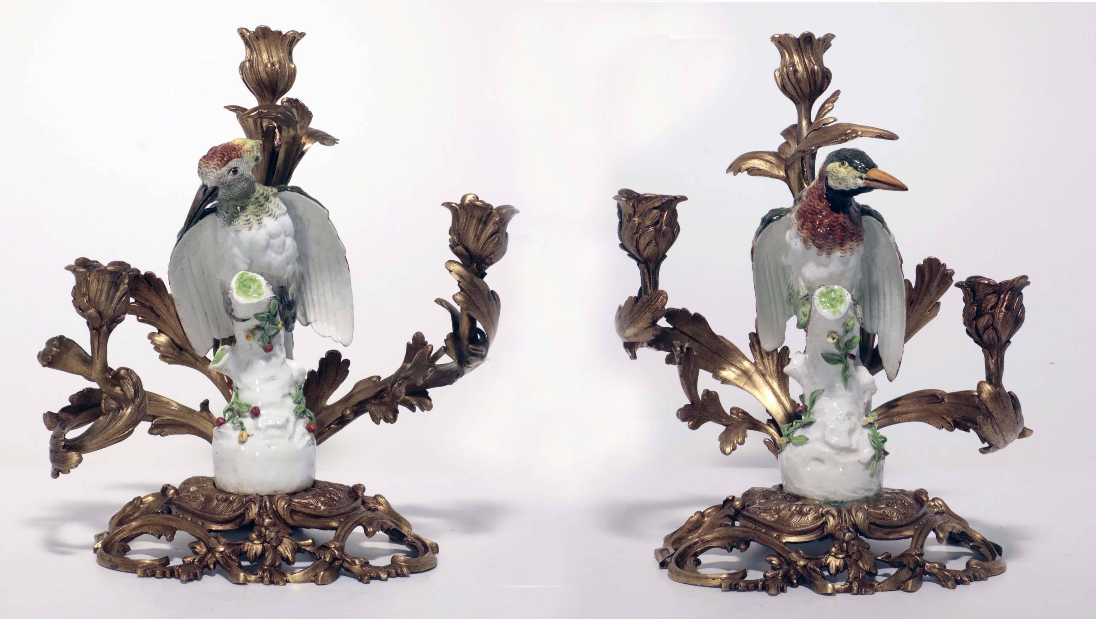 Each bird is modeled on a stump applied with plants and moss. They are naturalistically modeled with colorful plumage. The birds are mid-19th century at latest. The bronze mounts are early 20th century modeled as stylized acanthus and support three