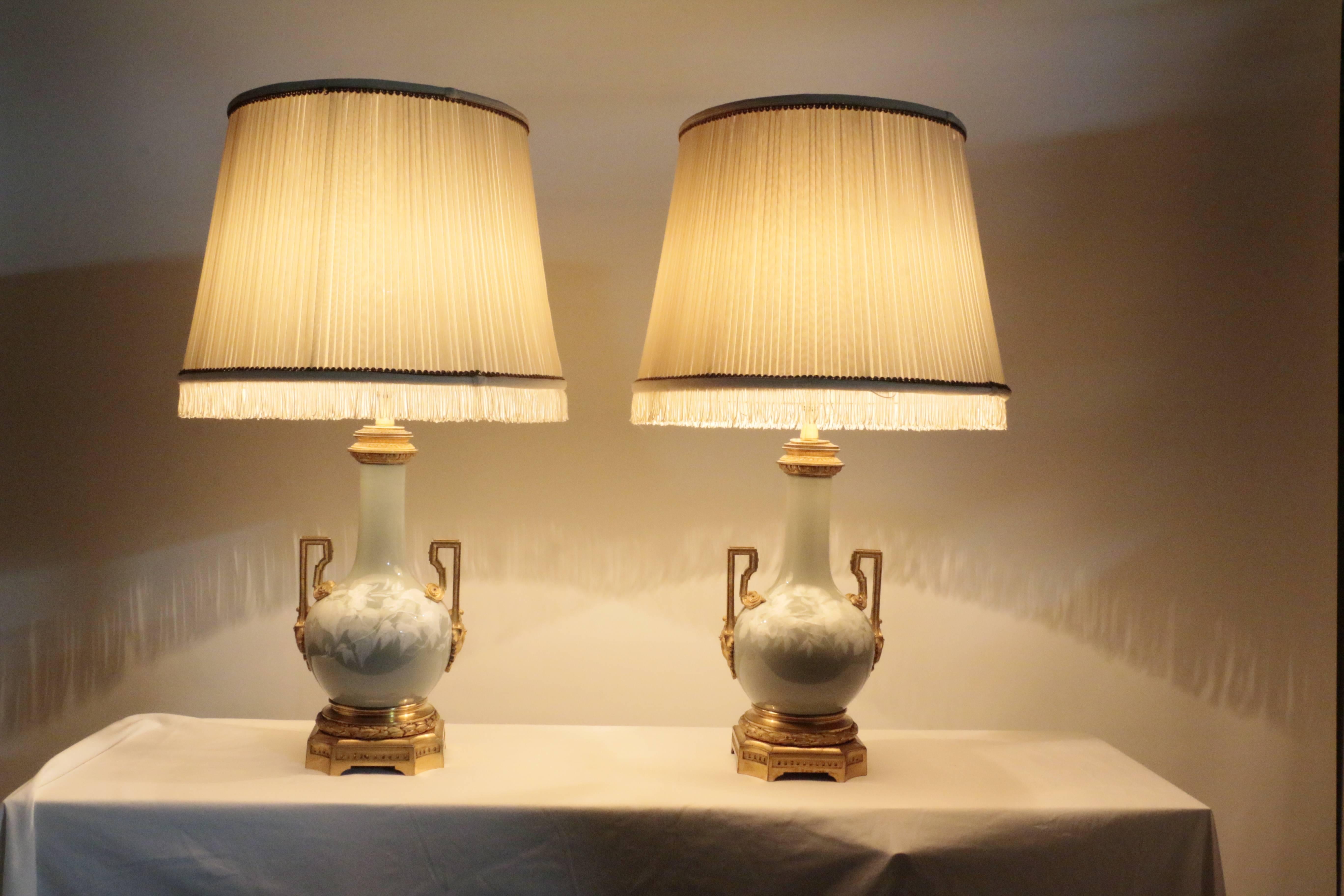 
A good pair of antique French celadon and pate sur pate two handled bottle shaped vases. Each is finely cast with gilt bronze handles and bases.
The technique of pate sur pate was popular in France and was there associated with the Sevres factory