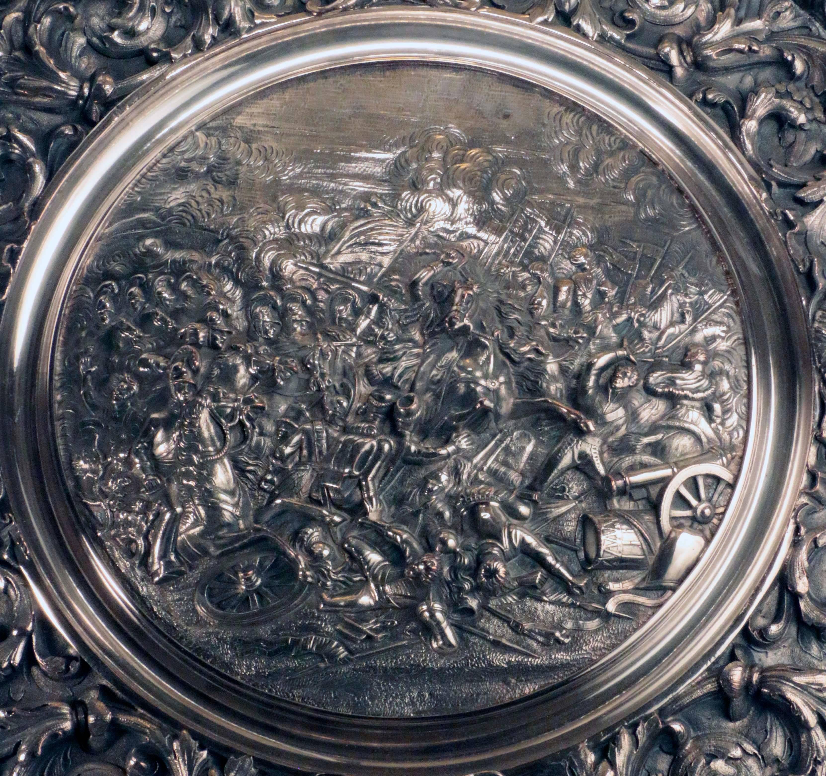 A sumptuous sideboard dish cast with, the decisive charge of the lifeguards at the battle of Waterloo. After Luke Clennell, 1769-1842. The central panel of
this plated dish celebrates the dramatic moment when the British heavy cavalry clash with