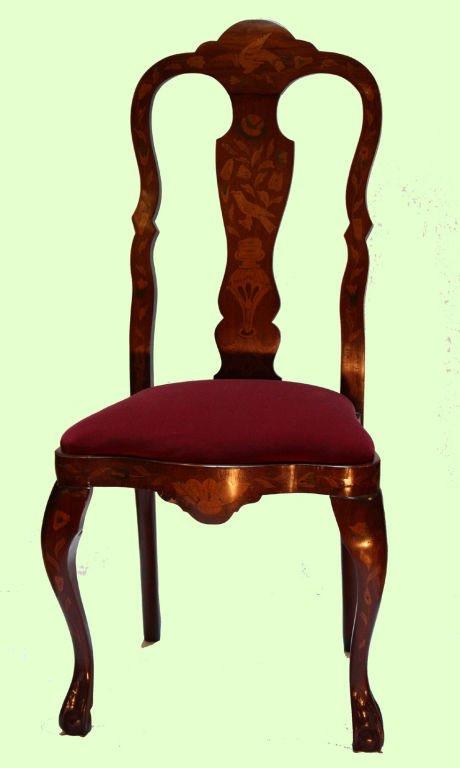 Pair of  Dutch mahogany  and marquetry  chairs inlaid with birds and flowers with vase shaped splat and shaped toprail  over red velvet seat with shaped apron raised on cabriole legs on ball and claw feet.