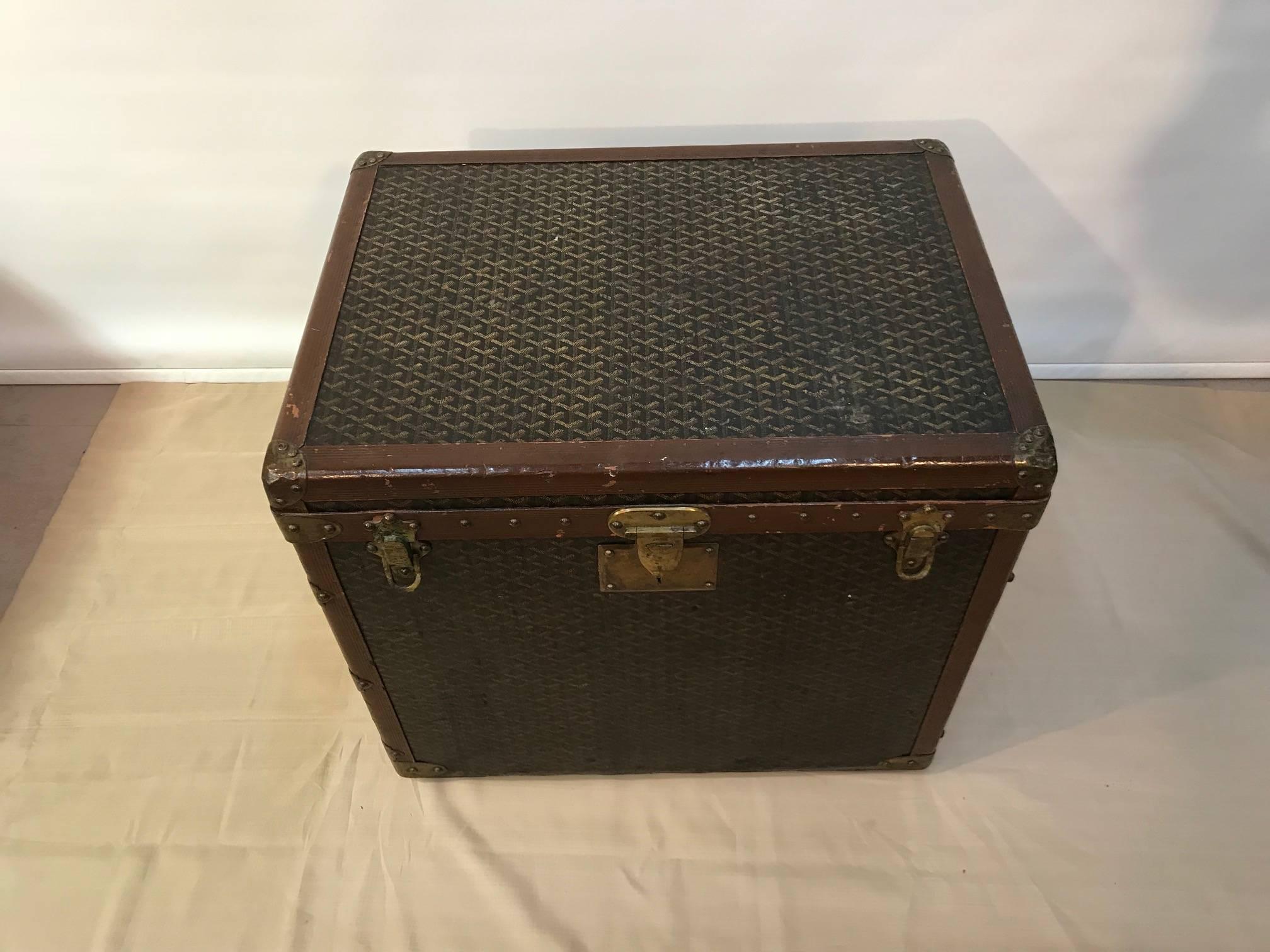 This superb trunk by the leading luggage maker of his day, opens first with a rising top to reveal a segmented compartment lined in tan baize, above a similarly lined drawer. Originally these were for shoes. The rest of the trunk is open and lined