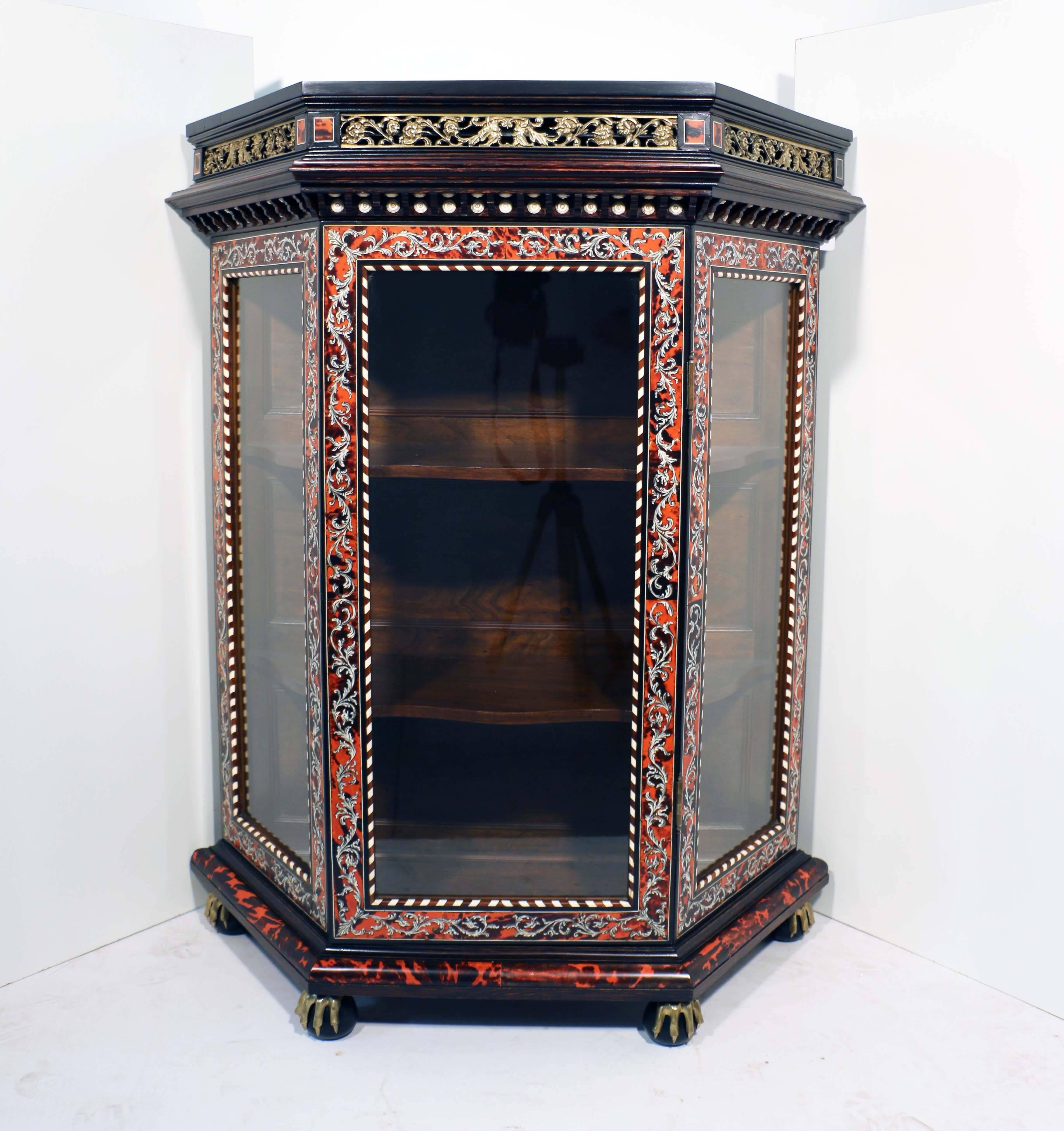 This sumptuous pair of salon cabinets are what the French call meubles d'appui. Each is enclosed by a single glazed door and with canted sides. They are partie and contrepartie; that is to say that one is veneered in scarlet with bone marquetry