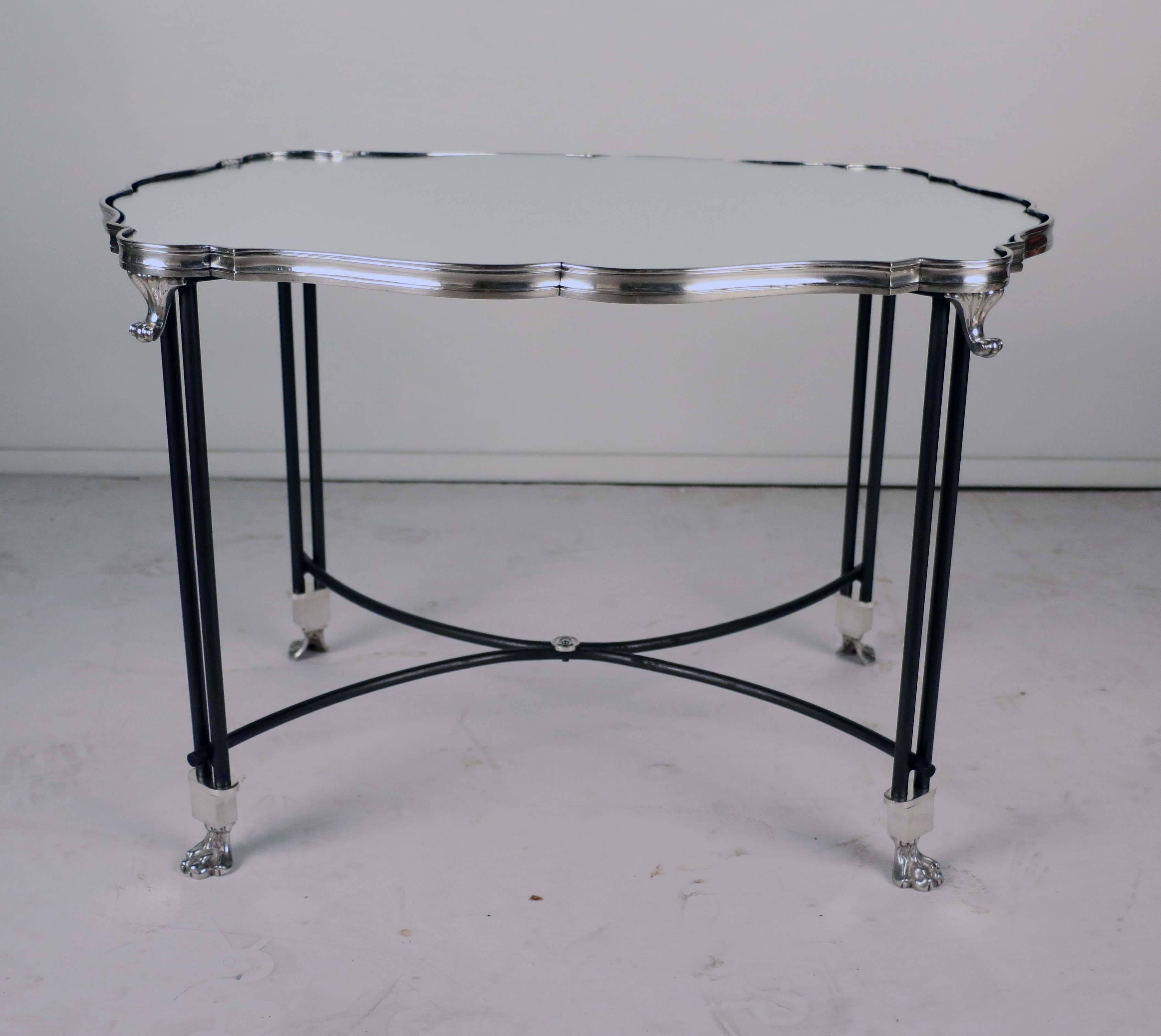 This is a table lake in a shaped Louis XV style silver-plated frame and on scrolling cabriole legs. The stand, which is later, is custom-made and on silver plated lion paw feet. The oxidised iron curved stretcher adds a certain elegance and