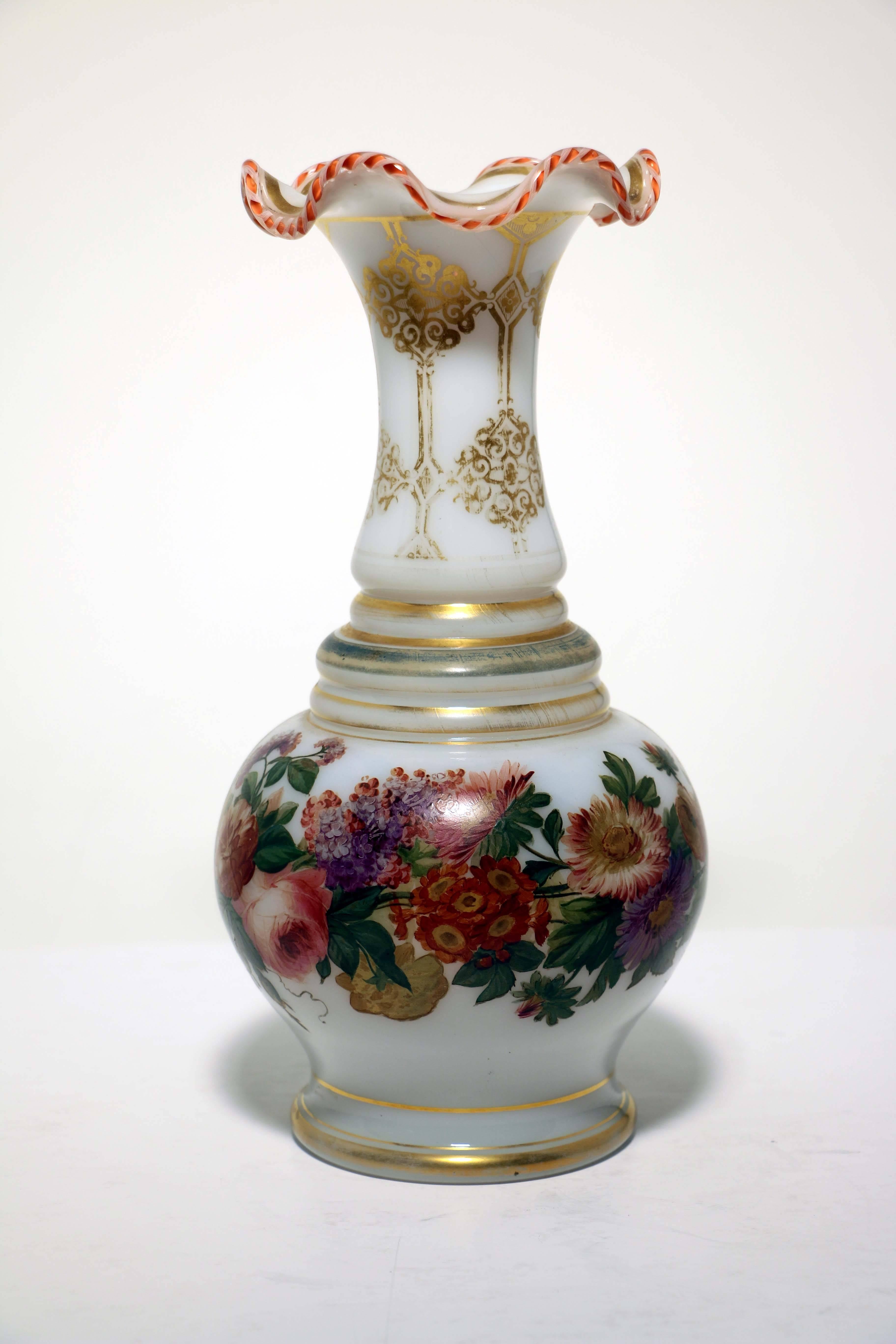 This pair of vases we attribute to Baccarat. They are part of a recently acquired group formed by a Swiss collector in the 1920s. The other items were all Baccarat. The baluster body is freely painted with wild flowers and leaves, it is gilded in