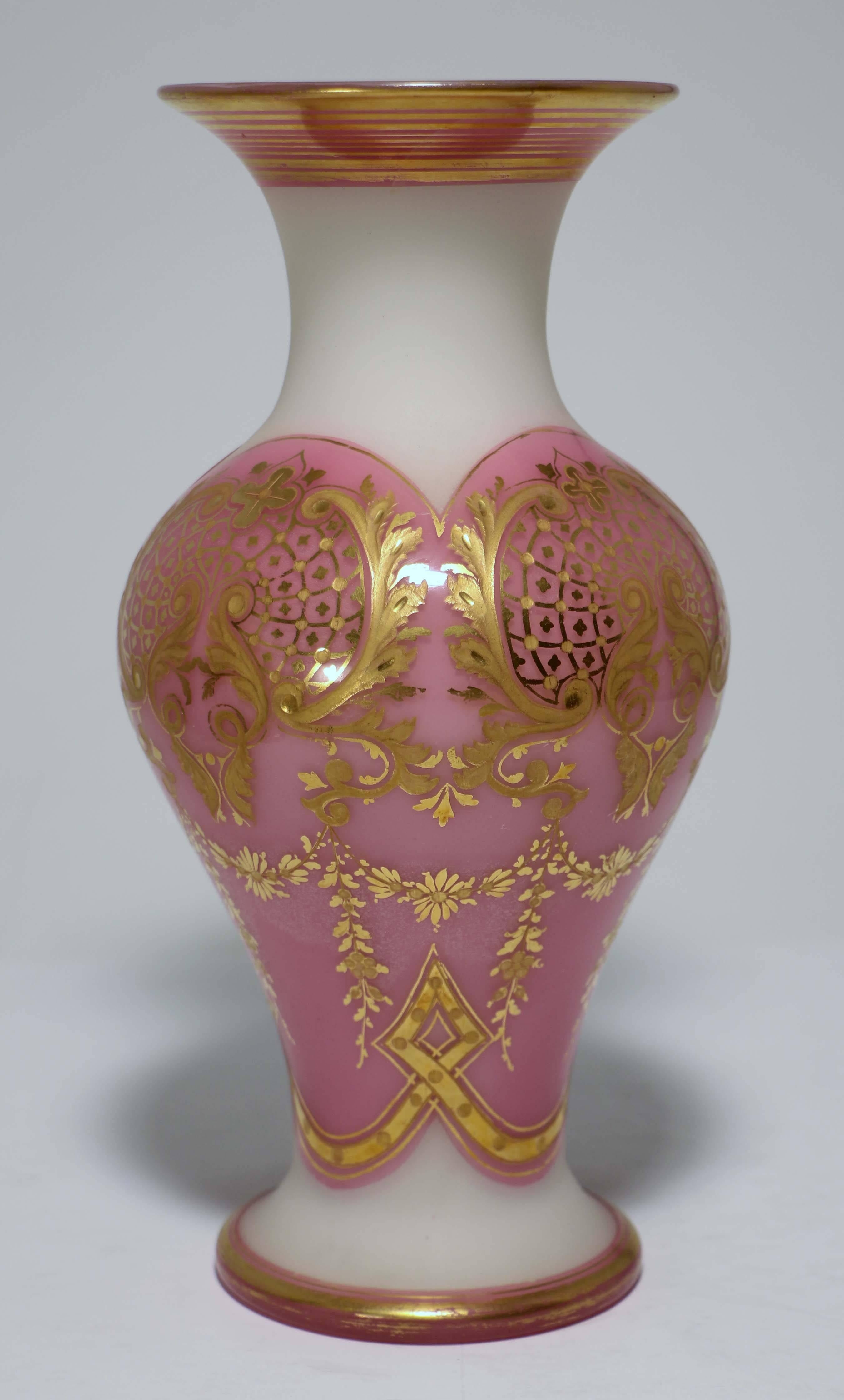 A Baccarat white opaline glass vase, overlaid and gilt. This baluster vase is a fine example of the extraordinary workmanship of this period. The opaline body has been cased in pink glass, cut back to clear, leaving a band at top and base. The body