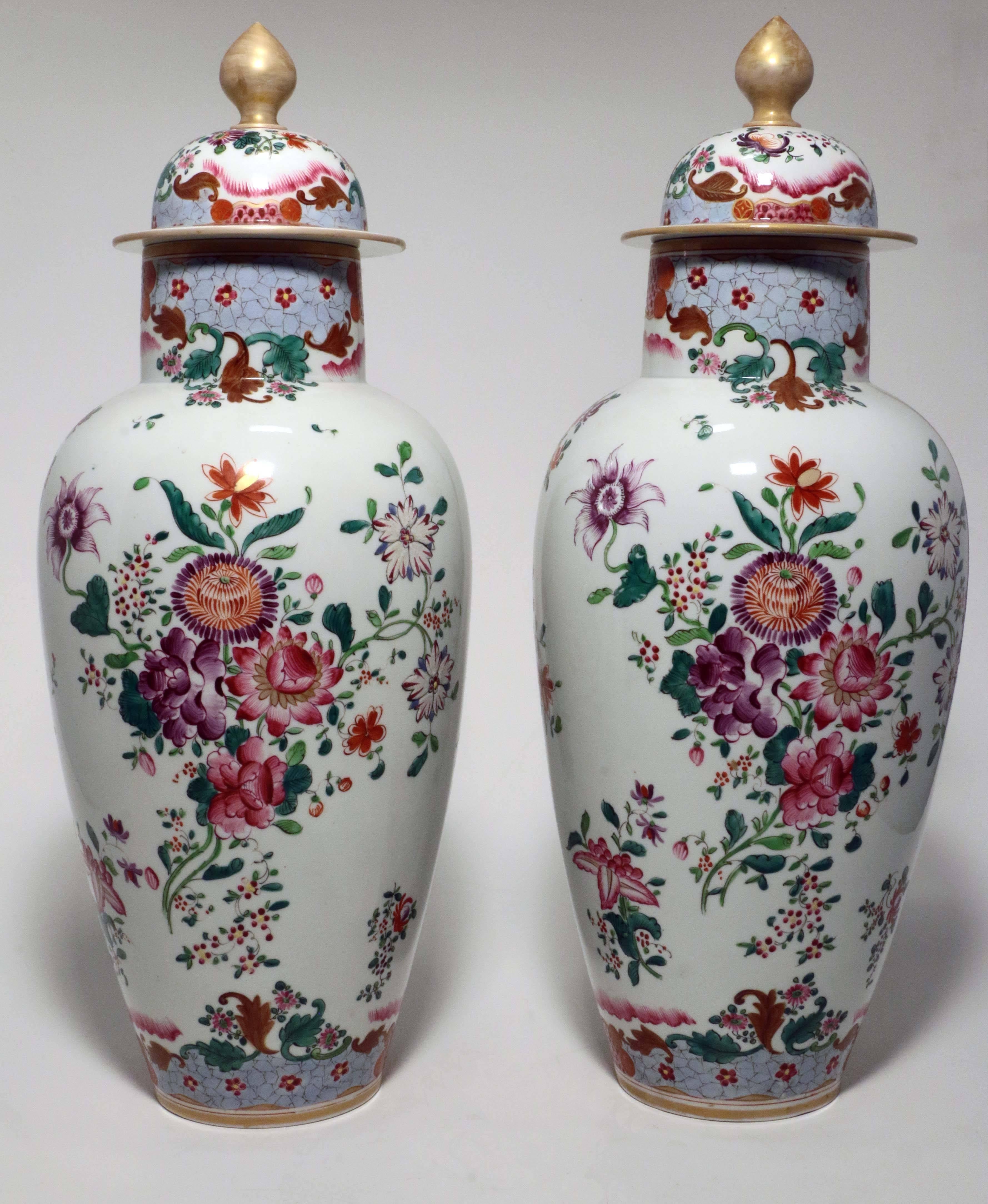This highly decorative pair of Famille Rose vases are painted in typical palette with leaves, flowers with blue 