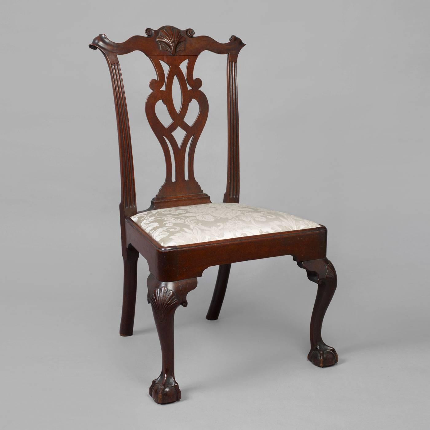 Philadelphia, ca. 1765-1780.
Mahogany, pine seat frame.
A wonderful example having a shaped, carved crest rail with a shell flanked by volutes and swept back ears above a carved pierced splat flanked by fluted stiles and a trapezoid slip-seat