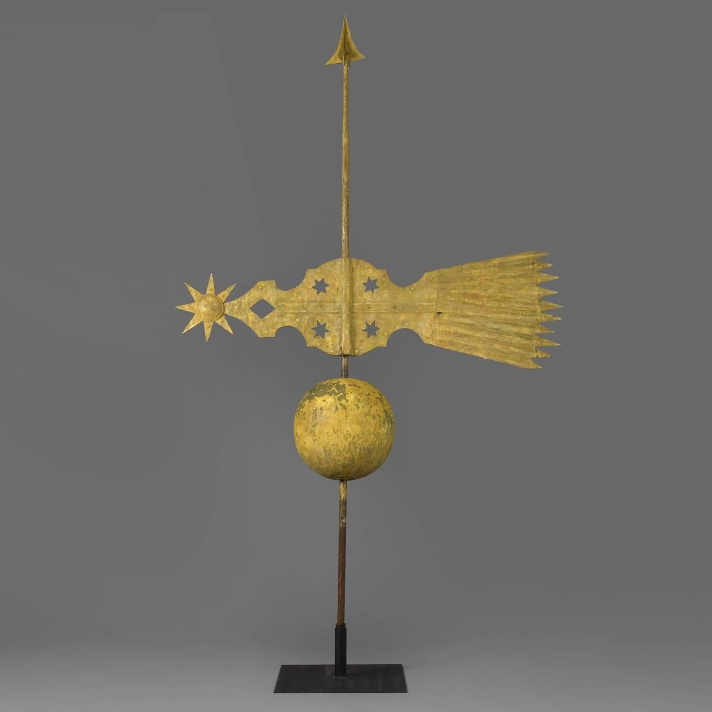 Having a spire finial and a large sphere below the banner. All mounted on the original wrought iron. post
American, mid-19th century.
Retains some of the original yellow sizing and some areas of gilt.
Sheet copper and wrought iron.