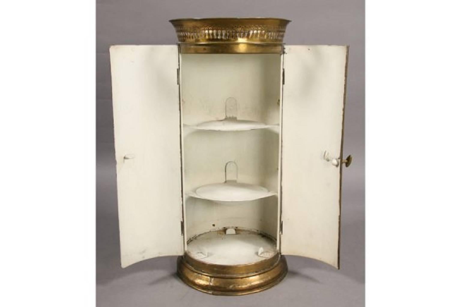 Empire style tole and brass cylindrical plate cabinet.

Two doors with two shelves within. Pierced brass crown.