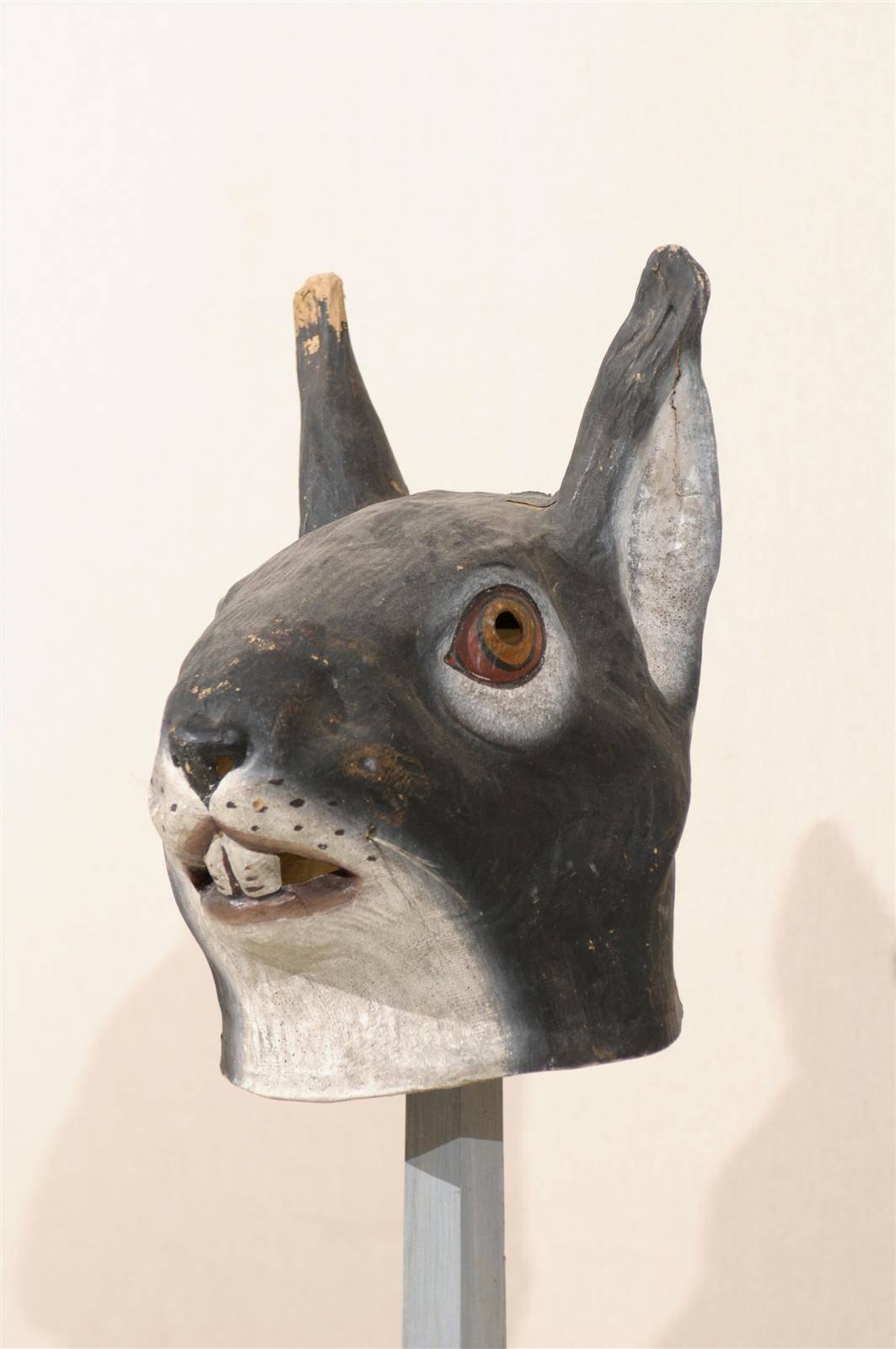 A collection of European Folk Art animal masks on custom stands. These Folk Art papier-mâché animal masks are from the early 20th century. The measurements below are for the rabbit mask.