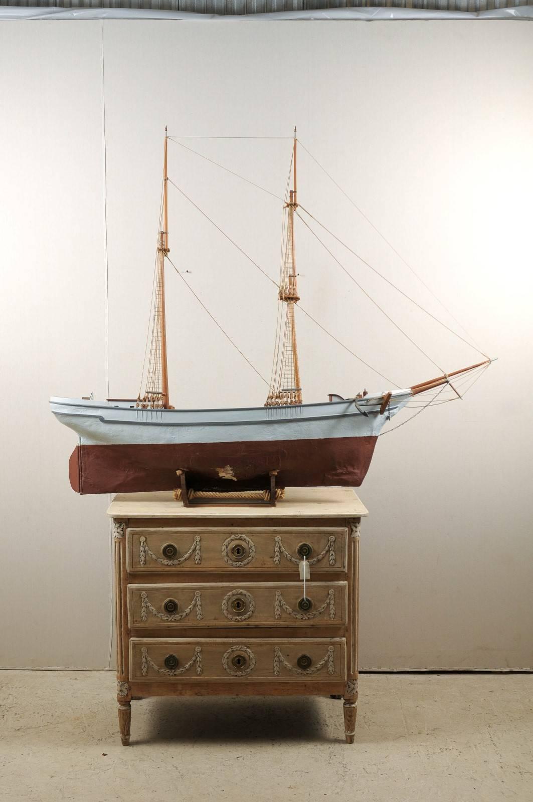 A Swedish two-masted ship model. This Swedish wooden ketch (or brigantine) wooden ship model from the 19th century is raised on a stand. A closer look reveals the minutia in the details, from the masts to the anchor. Nice aging with some wear on the