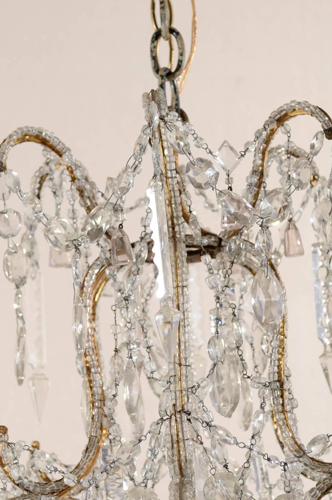French Crystal and Gilded Iron Chandelier with Scroll Arms and Ornate Beading In Good Condition In Atlanta, GA